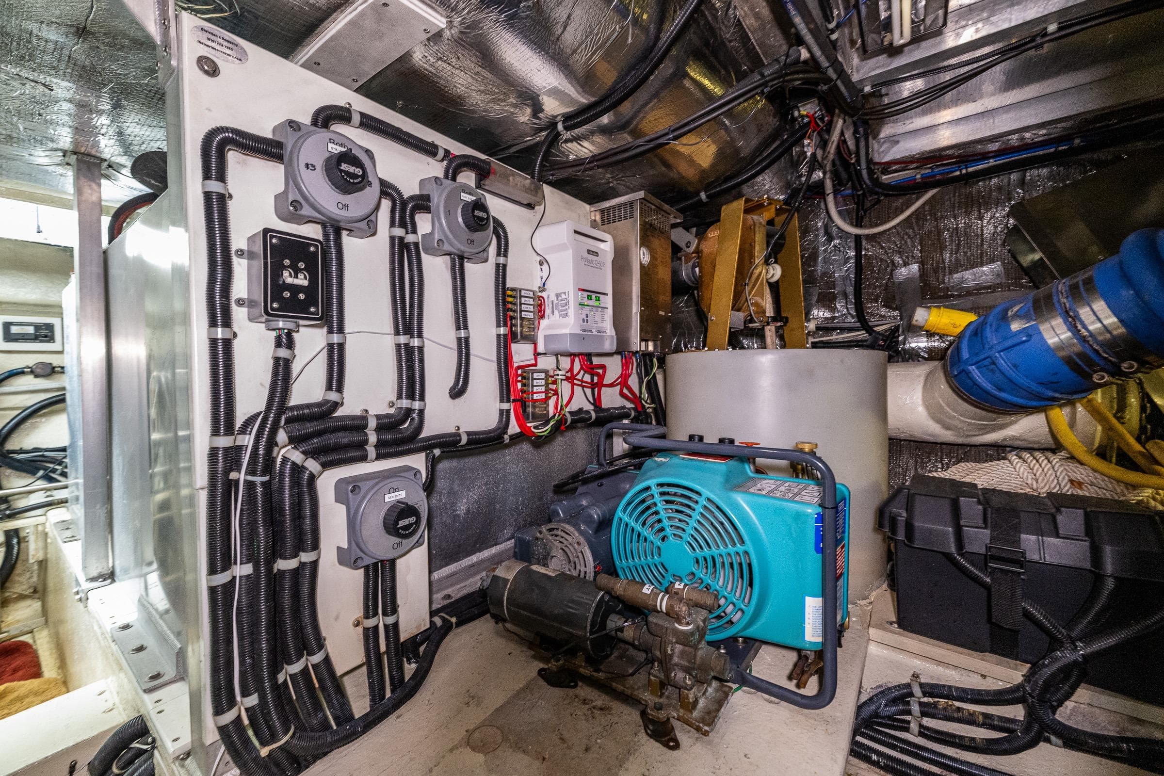Engine room of 2001 Navigator Pilothouse yacht with electrical systems and machinery.