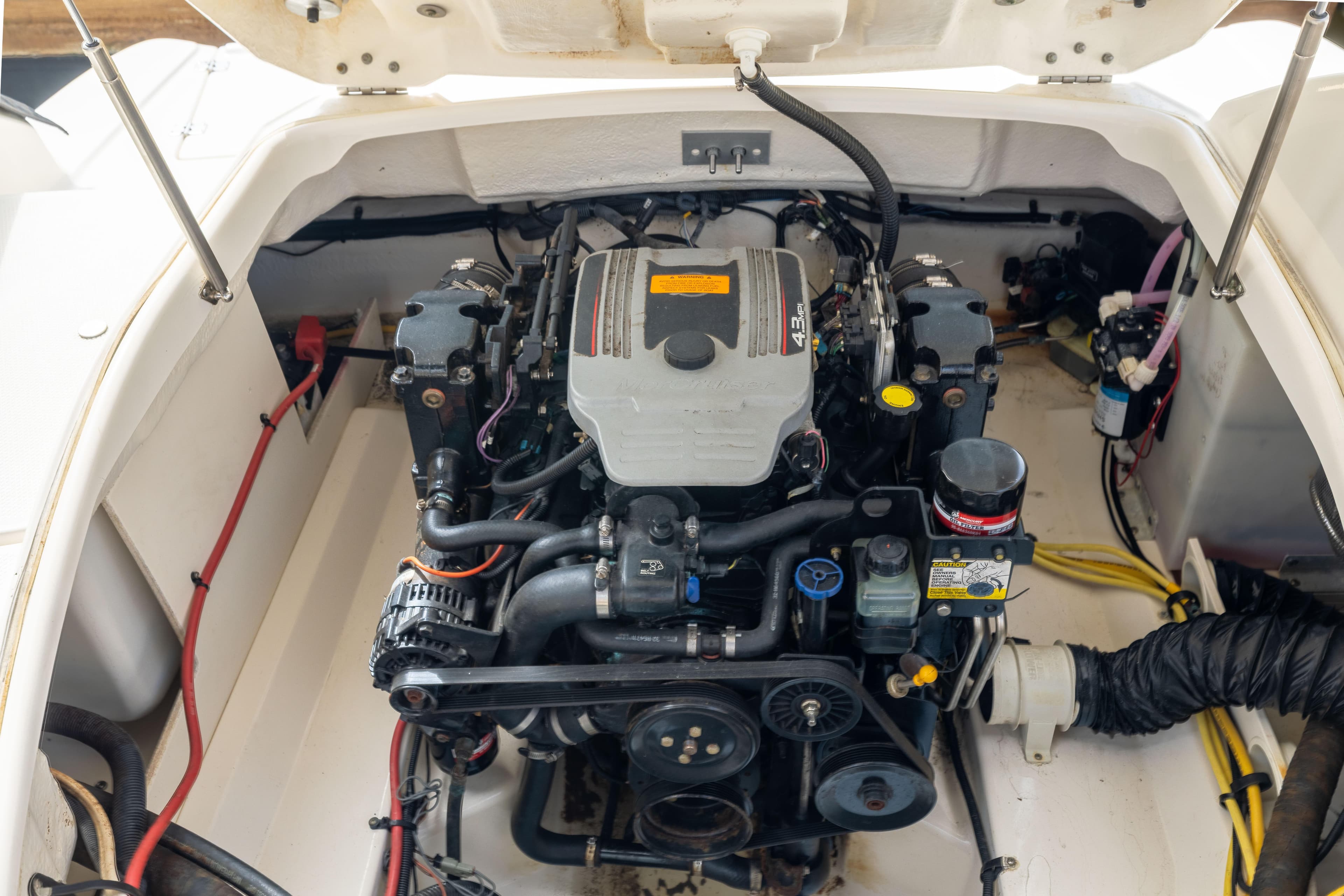 Engine compartment of a 2012 Chaparral 225 SSi boat, showcasing detailed mechanical components.