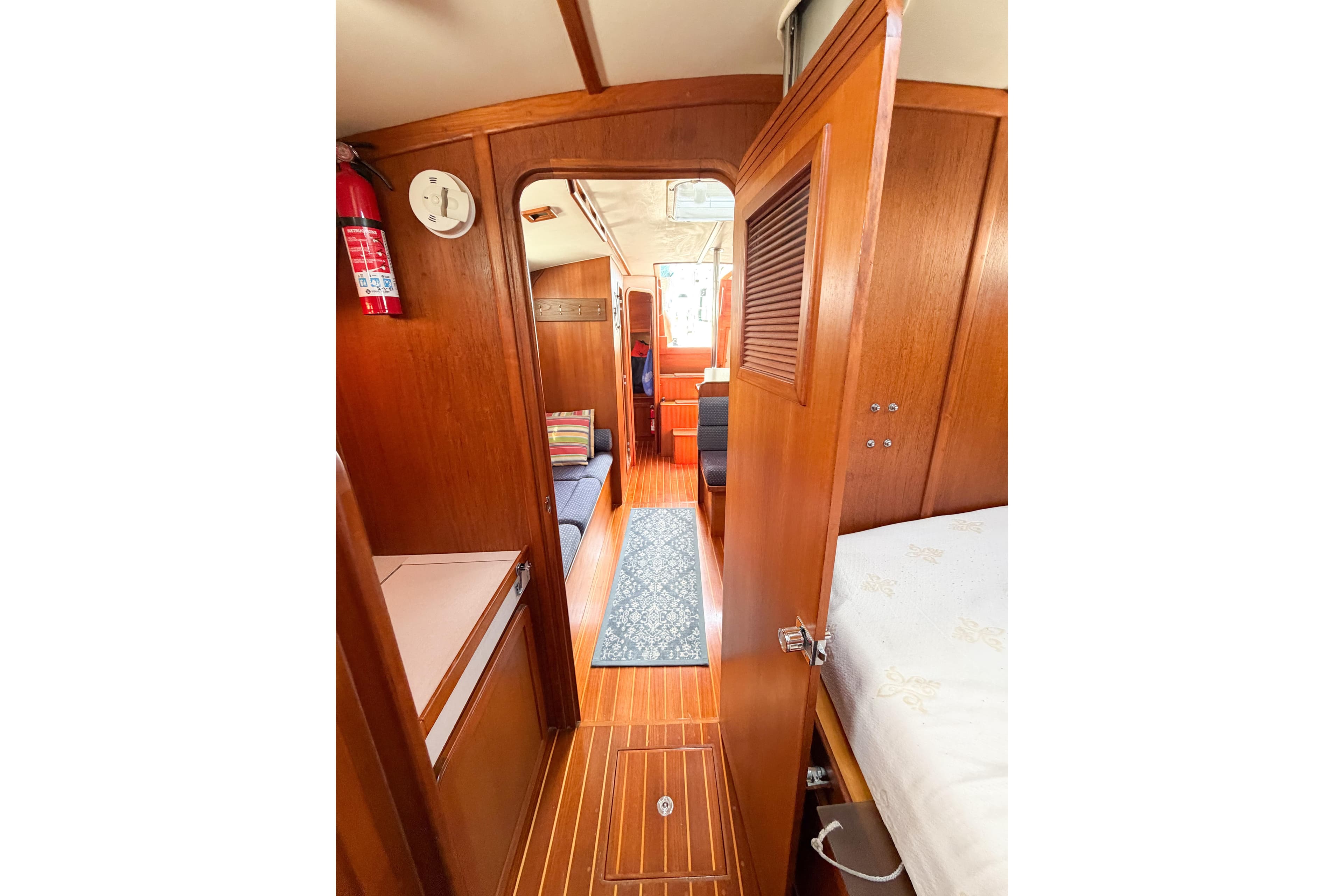 Interior view of 2001 Caliber 40LRC sailboat with wooden finish and cozy seating area.