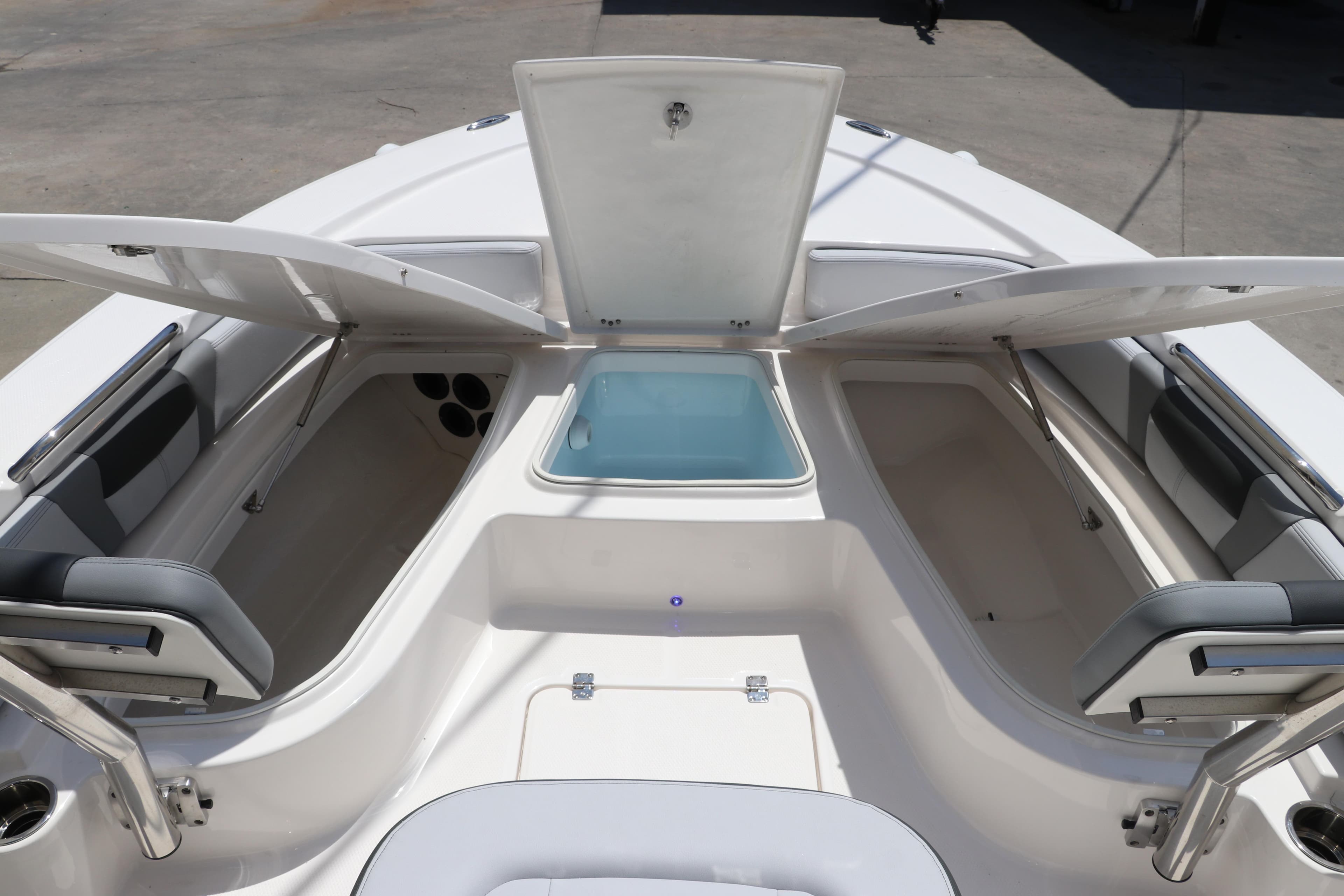2026 Robalo 226 Cayman boat interior with open storage compartments and seating.