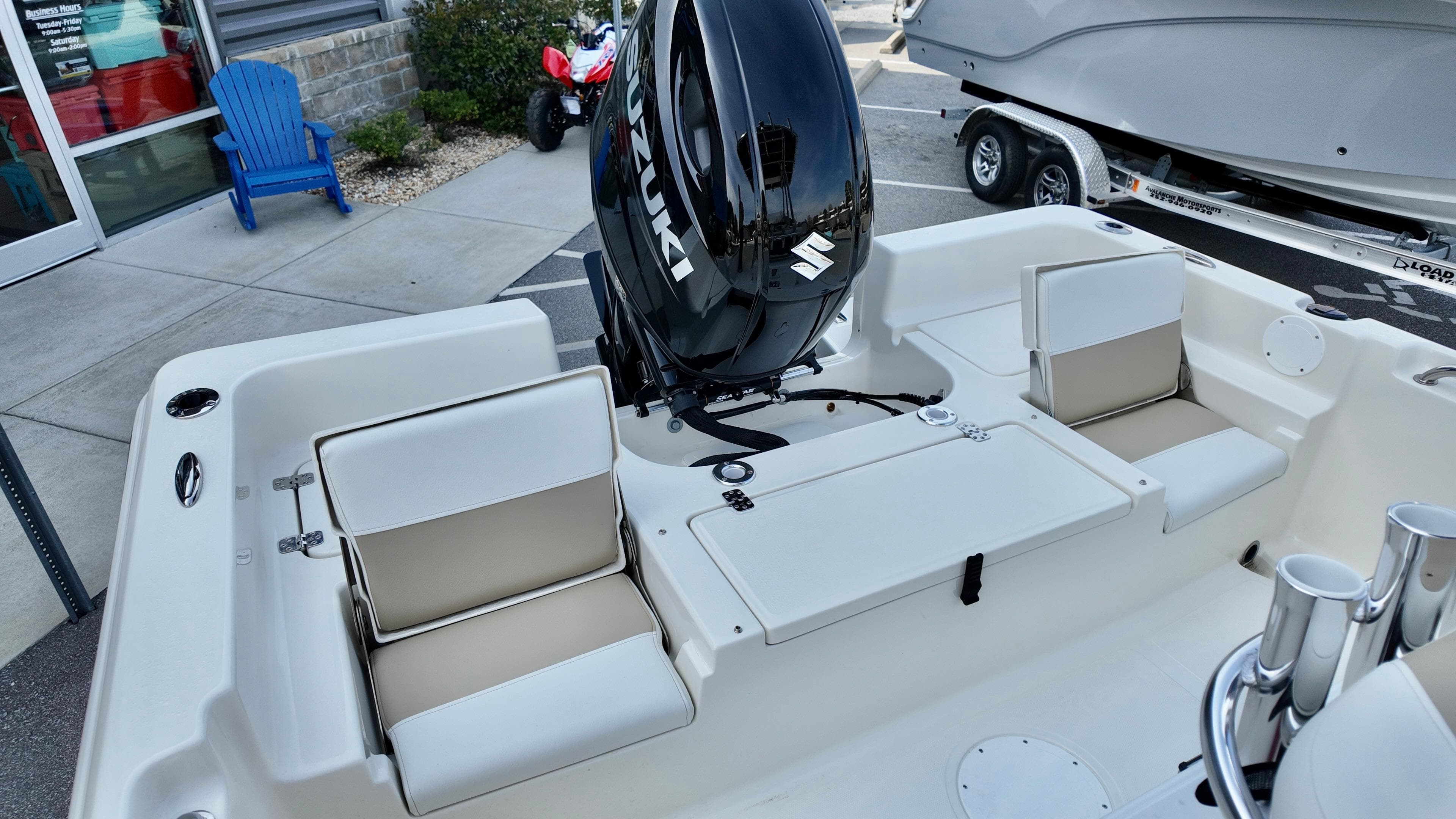 2026 Bulls Bay 2200 XS boat interior with Suzuki outboard motor, featuring cushioned seating.