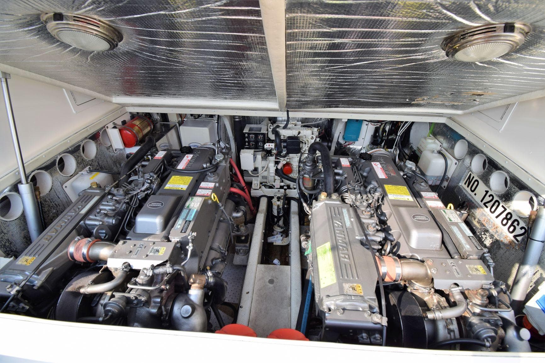 Engine compartment of a 2007 Carolina Classic 28 Express boat, showcasing dual engines.