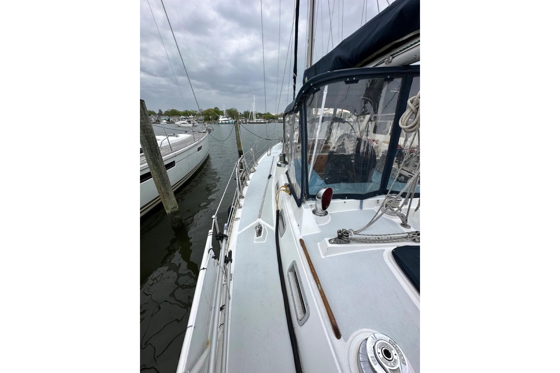 1989 Hylas 44 sailboat docked, featuring deck and rigging details under cloudy skies.