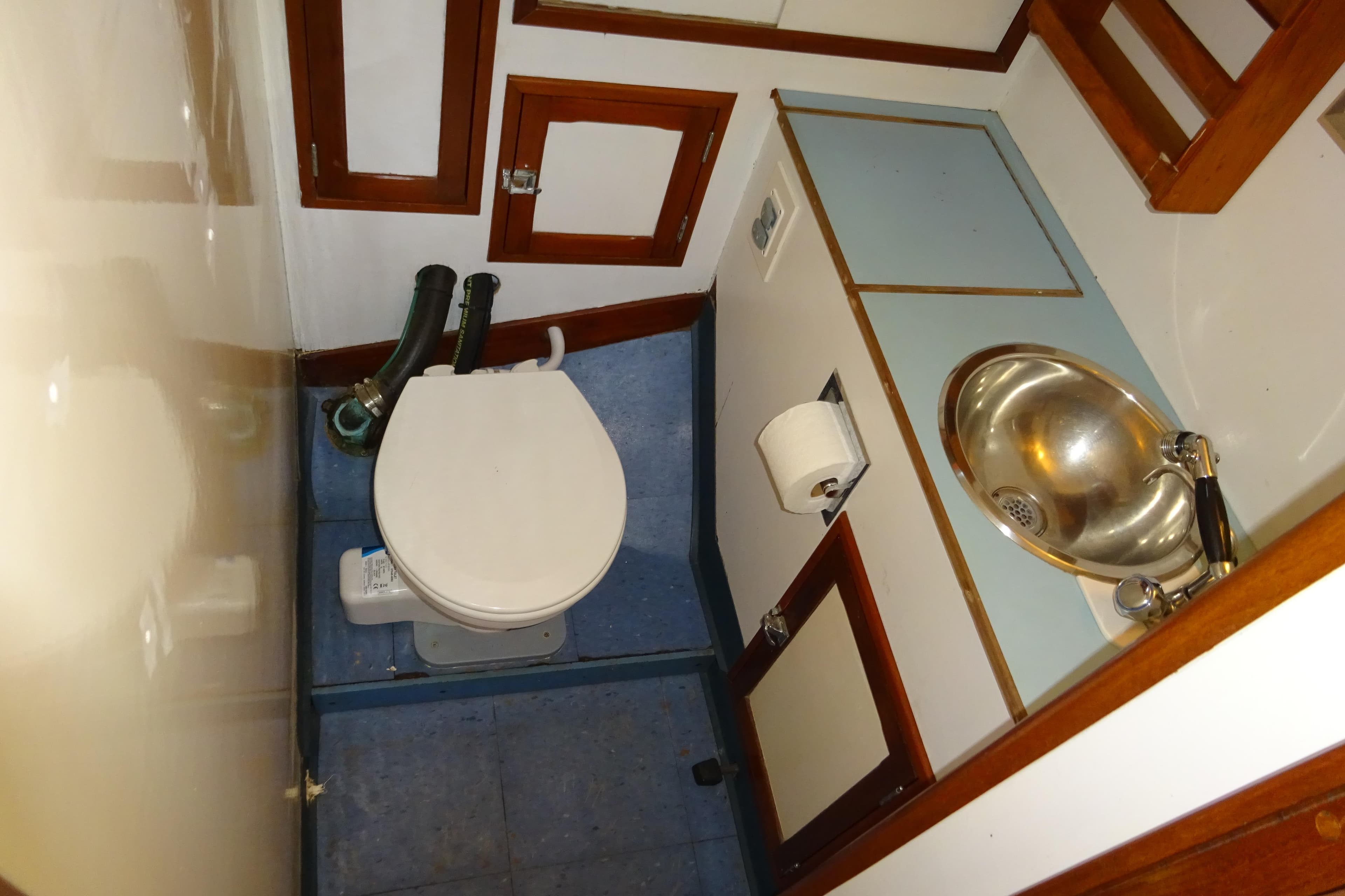 1970 Hinckley Bermuda 40 Custom yacht bathroom with toilet and stainless steel sink.