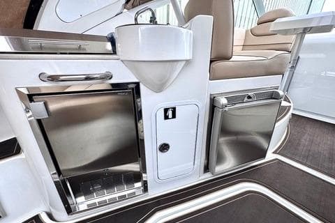 2015 Cruisers Yachts 380 Express interior with sink, fridge, and seating area.