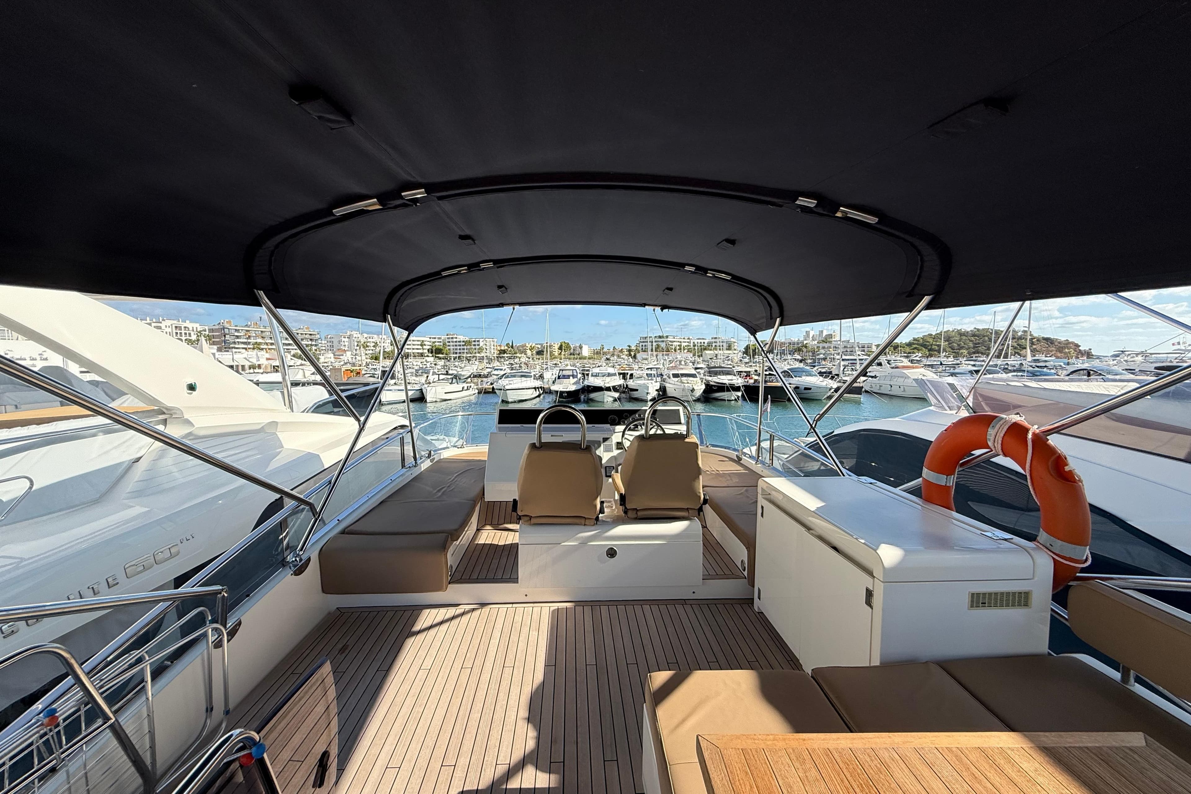 Luxurious 2012 Fairline Squadron 58 yacht interior with seating and marina view.