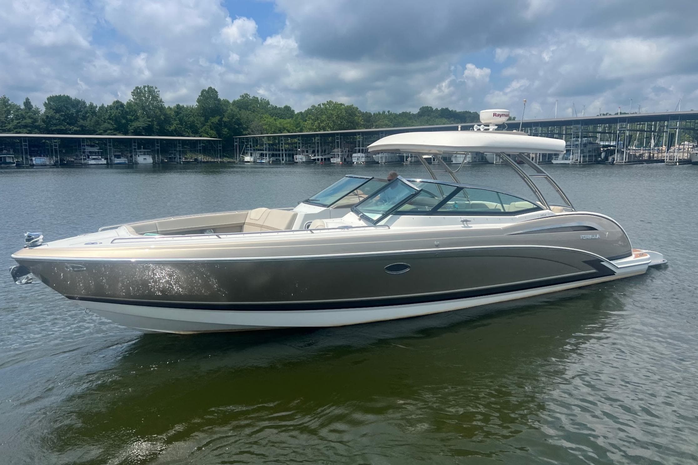 2014 Formula 350 Crossover Bowrider on calm water under a cloudy sky.