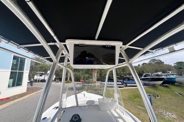 2016 Parker 21SE Center Console boat with T-top and electronics, docked outdoors.