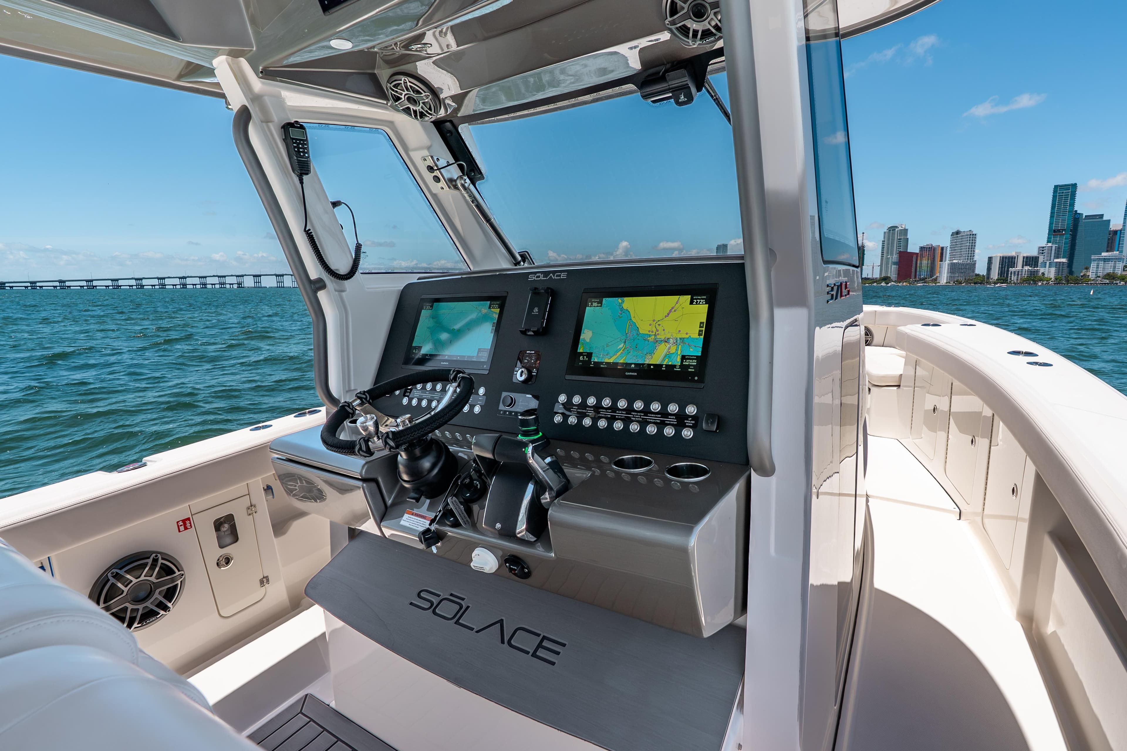 2026 Solace 37CS boat cockpit with advanced navigation system, steering wheel, and ocean view.