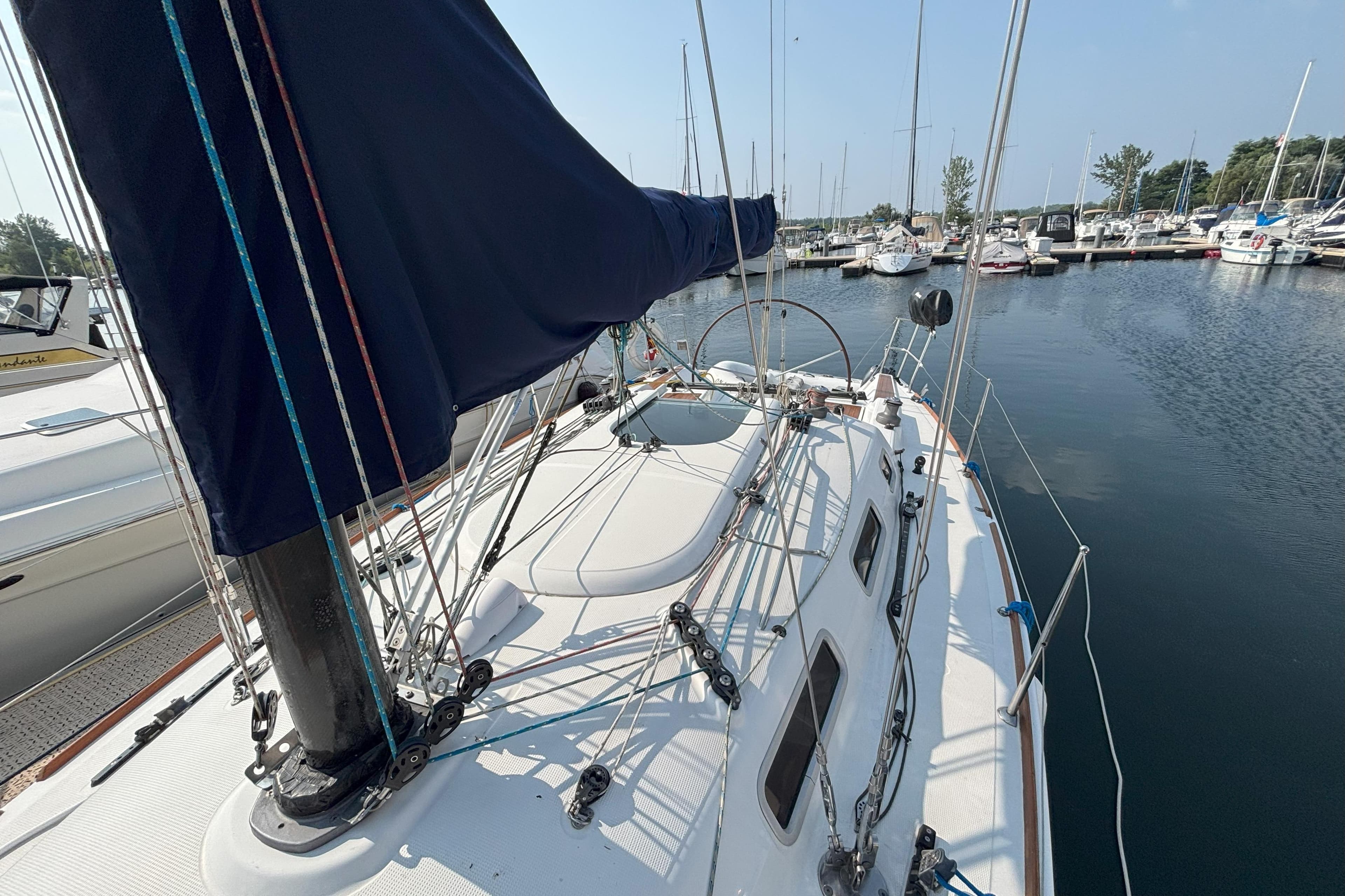 2008 Beneteau First 10R sailboat docked in a marina, showcasing deck and rigging.