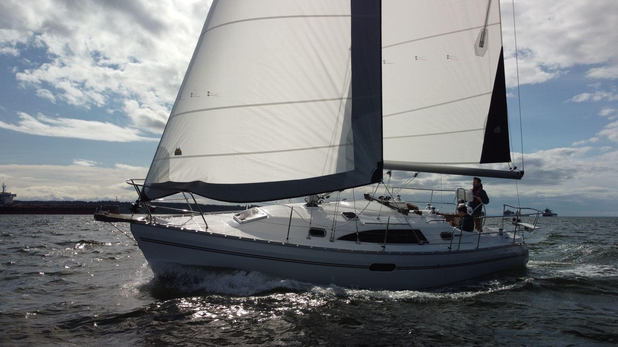 2023 Catalina 315 sailboat navigating open waters under clear skies.