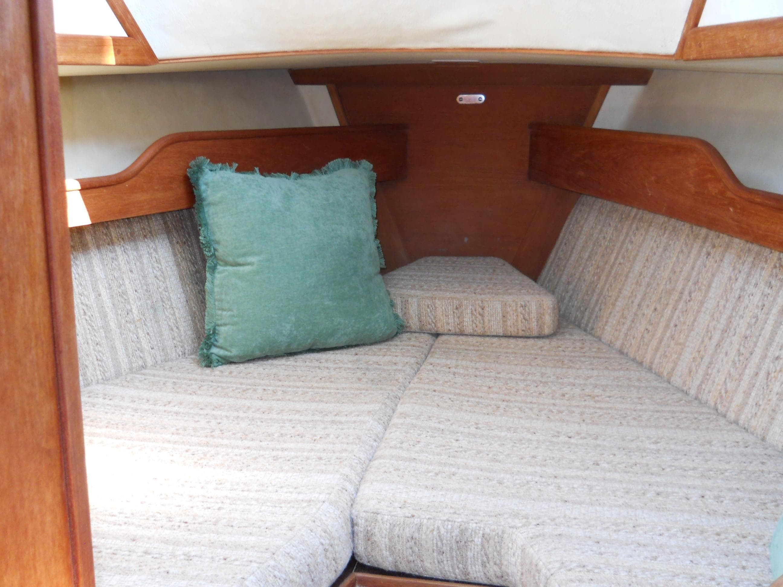 Cozy cabin interior of 1985 Sabre 38 MK I sailboat with cushioned seating.