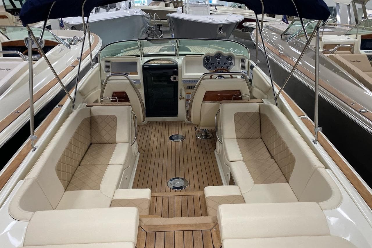 2019 Chris-Craft Corsair 30 boat interior with luxurious seating and wooden deck.