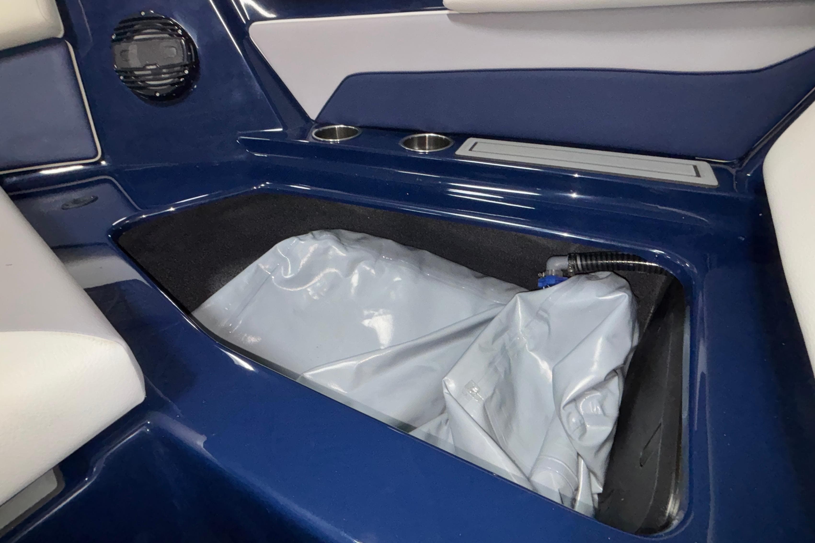 2026 ATX Surf Boats 24 Type-S interior storage compartment with blue and white seating.