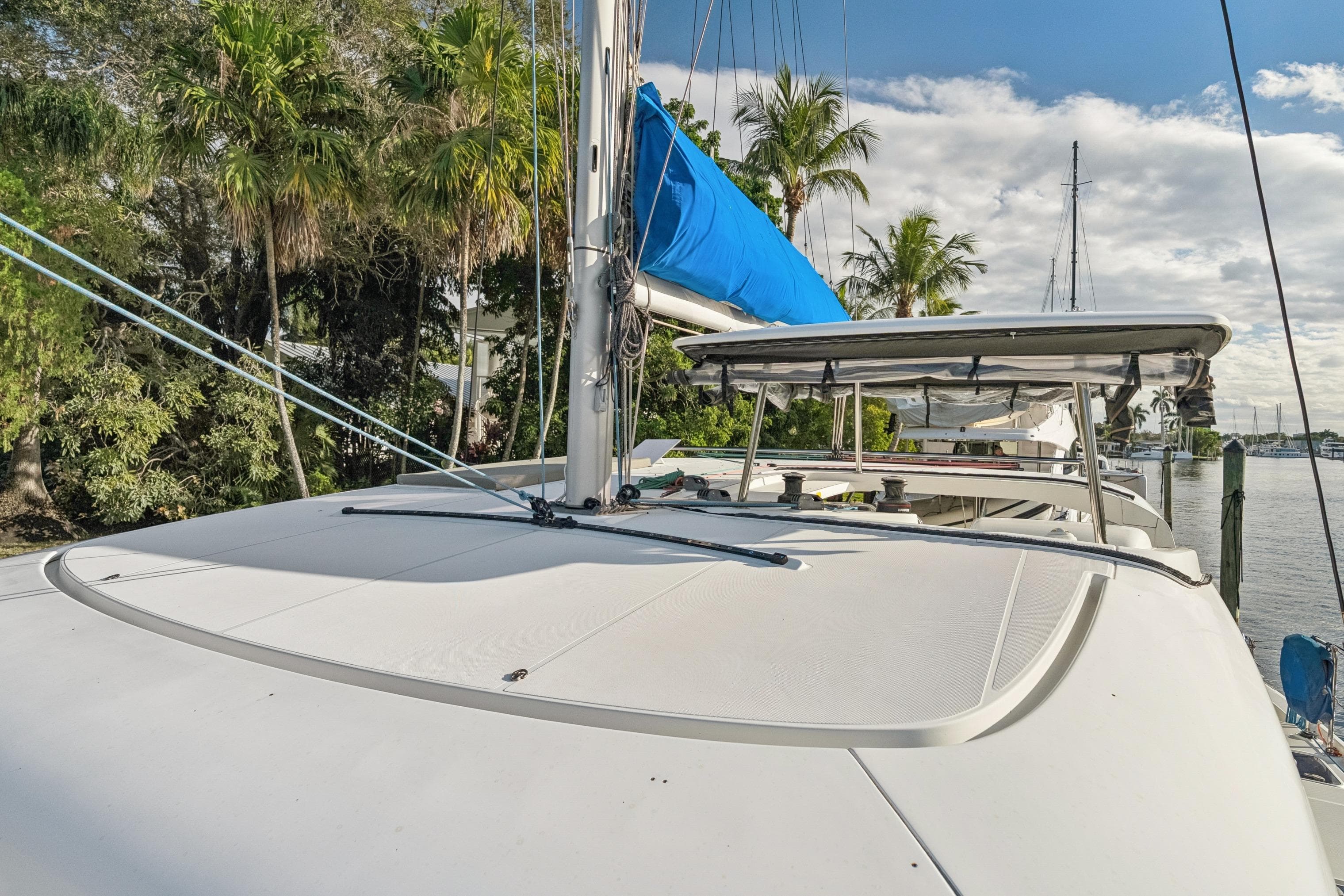 2020 Lagoon 42 catamaran docked, featuring a sleek design and blue sail cover.