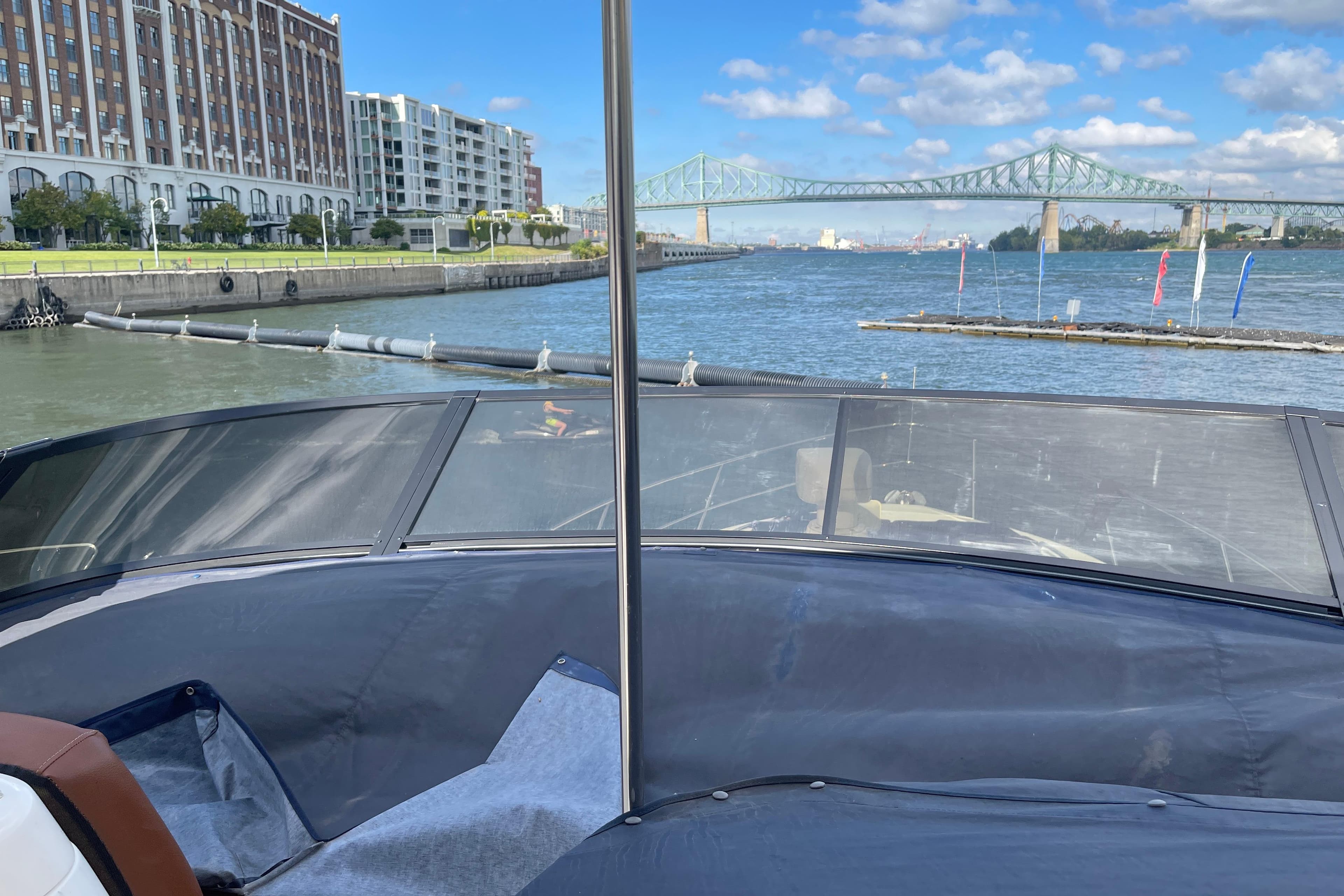 2004 Neptunus 56 Flybridge yacht on a river with cityscape and bridge view.