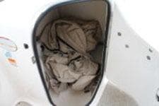 Storage compartment of 2002 Chaparral Sunesta 263 boat with fabric inside.