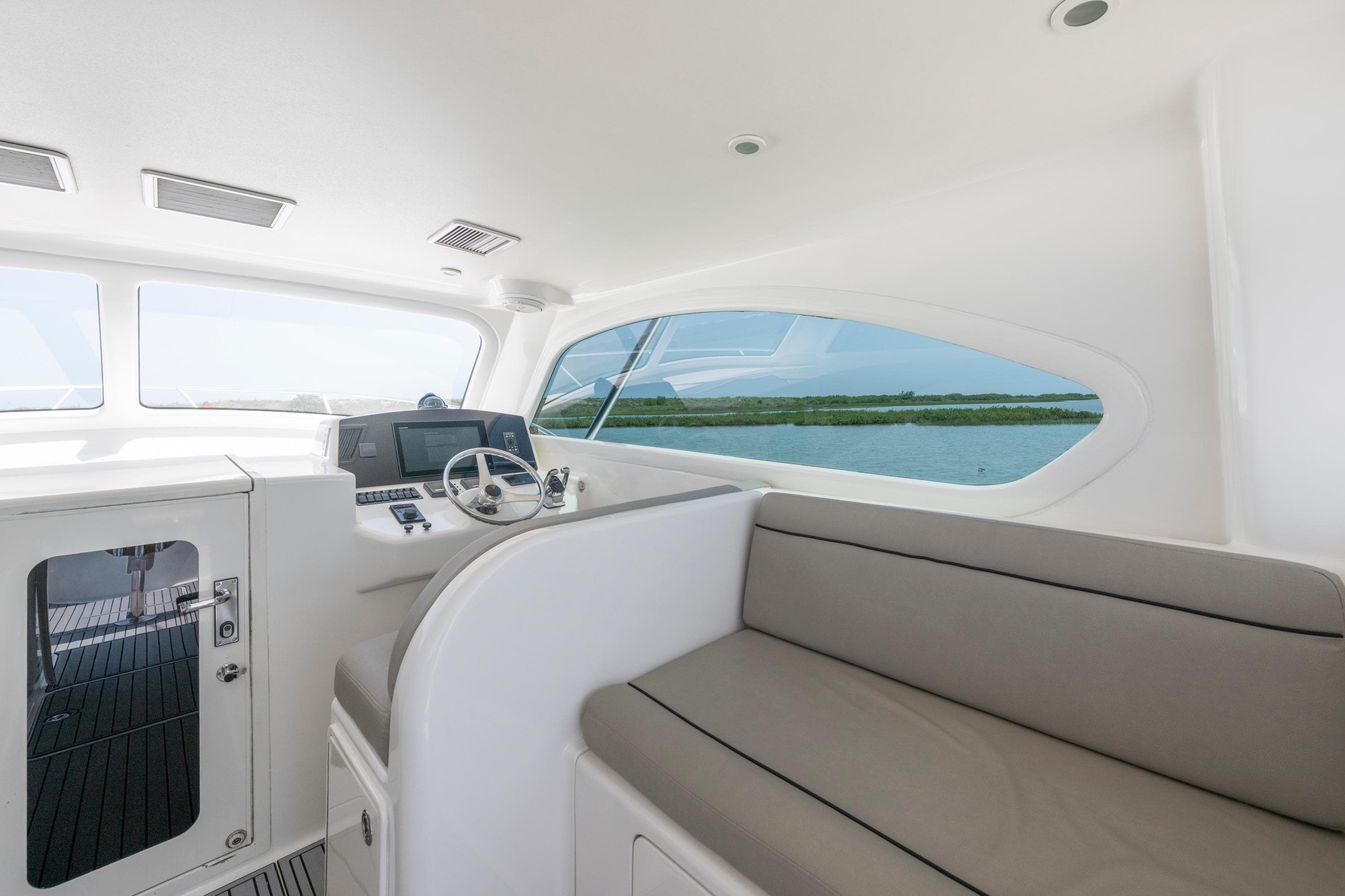 Interior of 2008 Ocean Yacht 37 Billfish, featuring helm and seating area with water view.