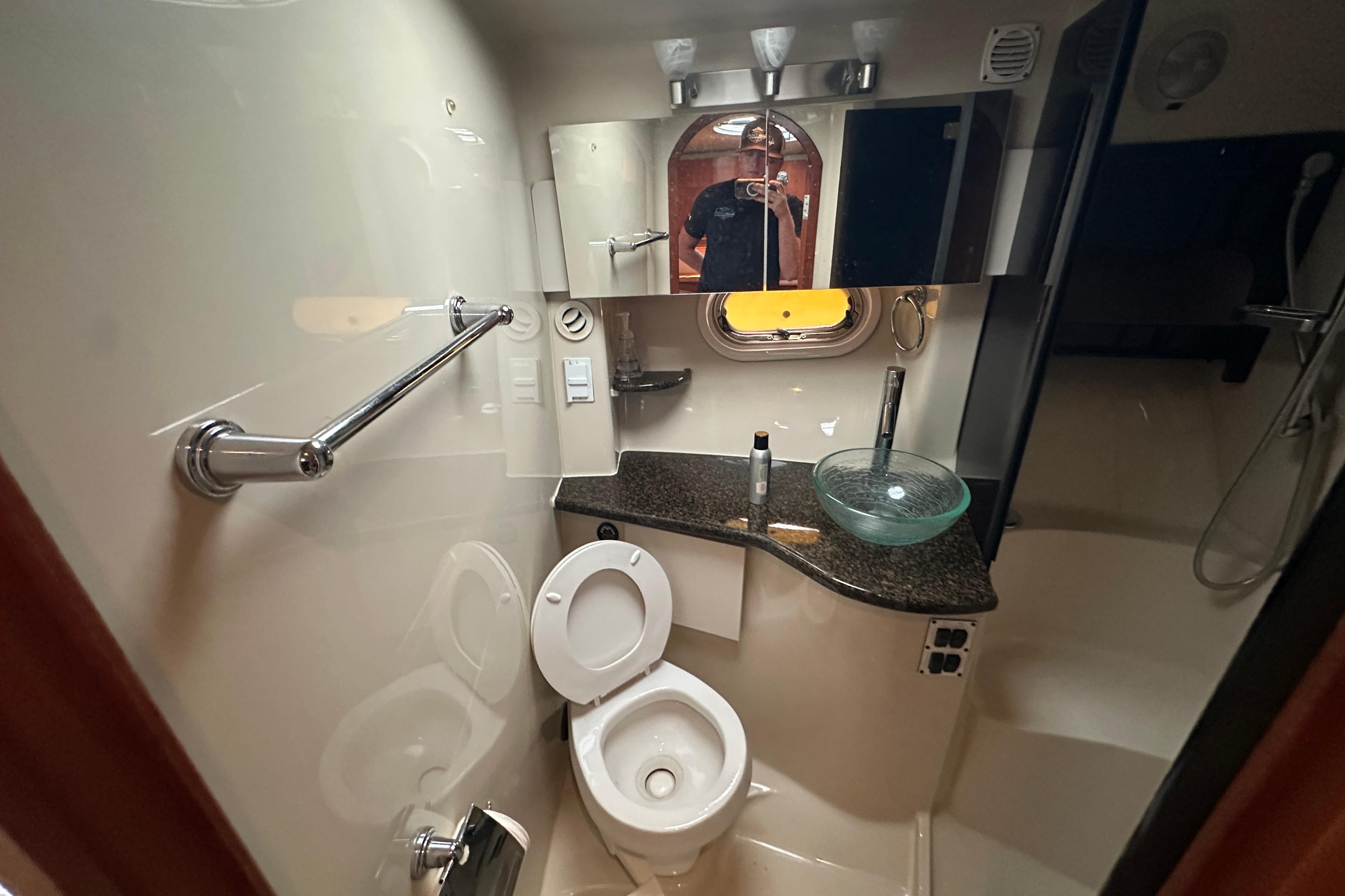 2006 Four Winns 378 Vista yacht bathroom with modern fixtures and glass sink.
