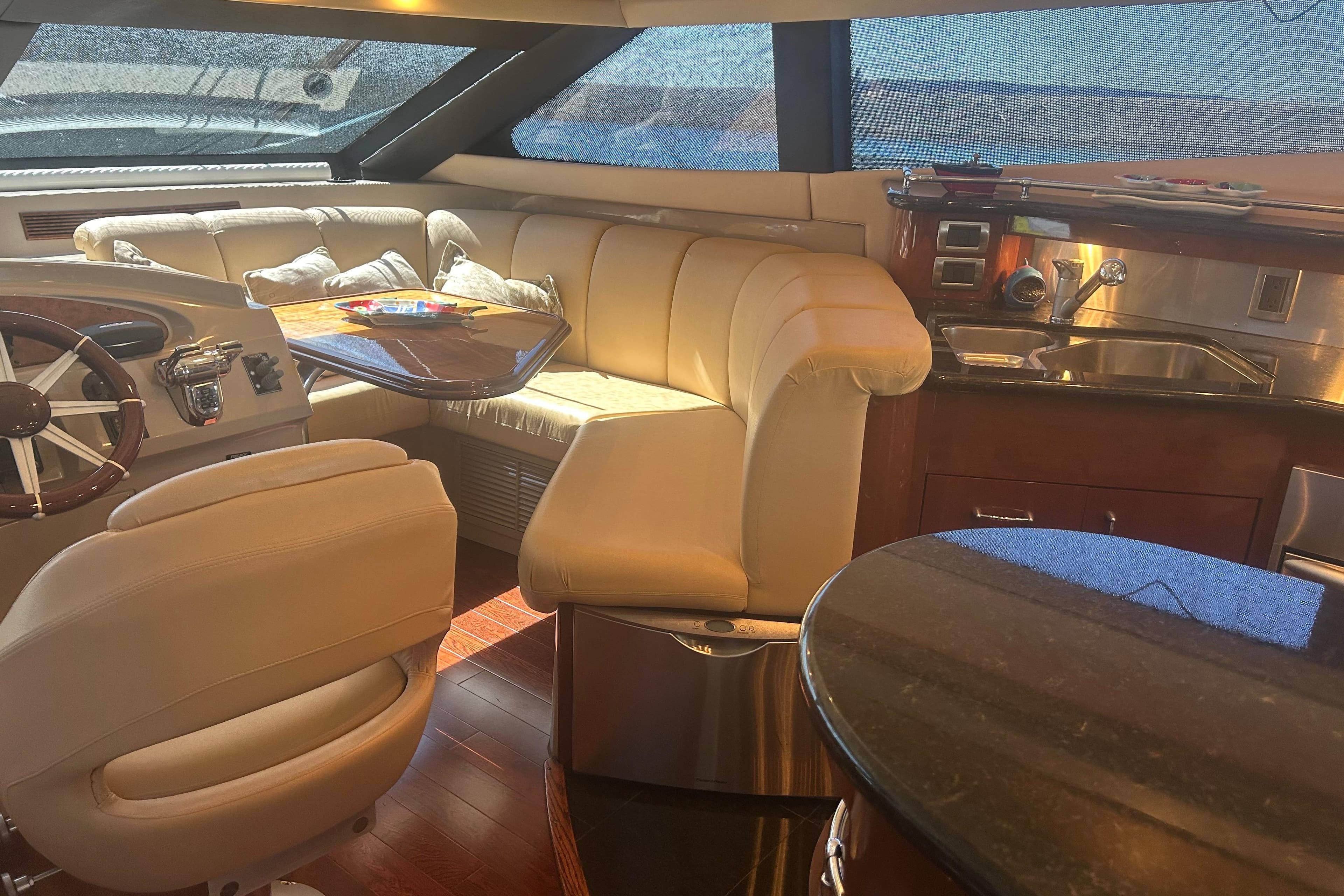 Luxurious interior of a 2006 Marquis 59 yacht with plush seating and modern amenities.