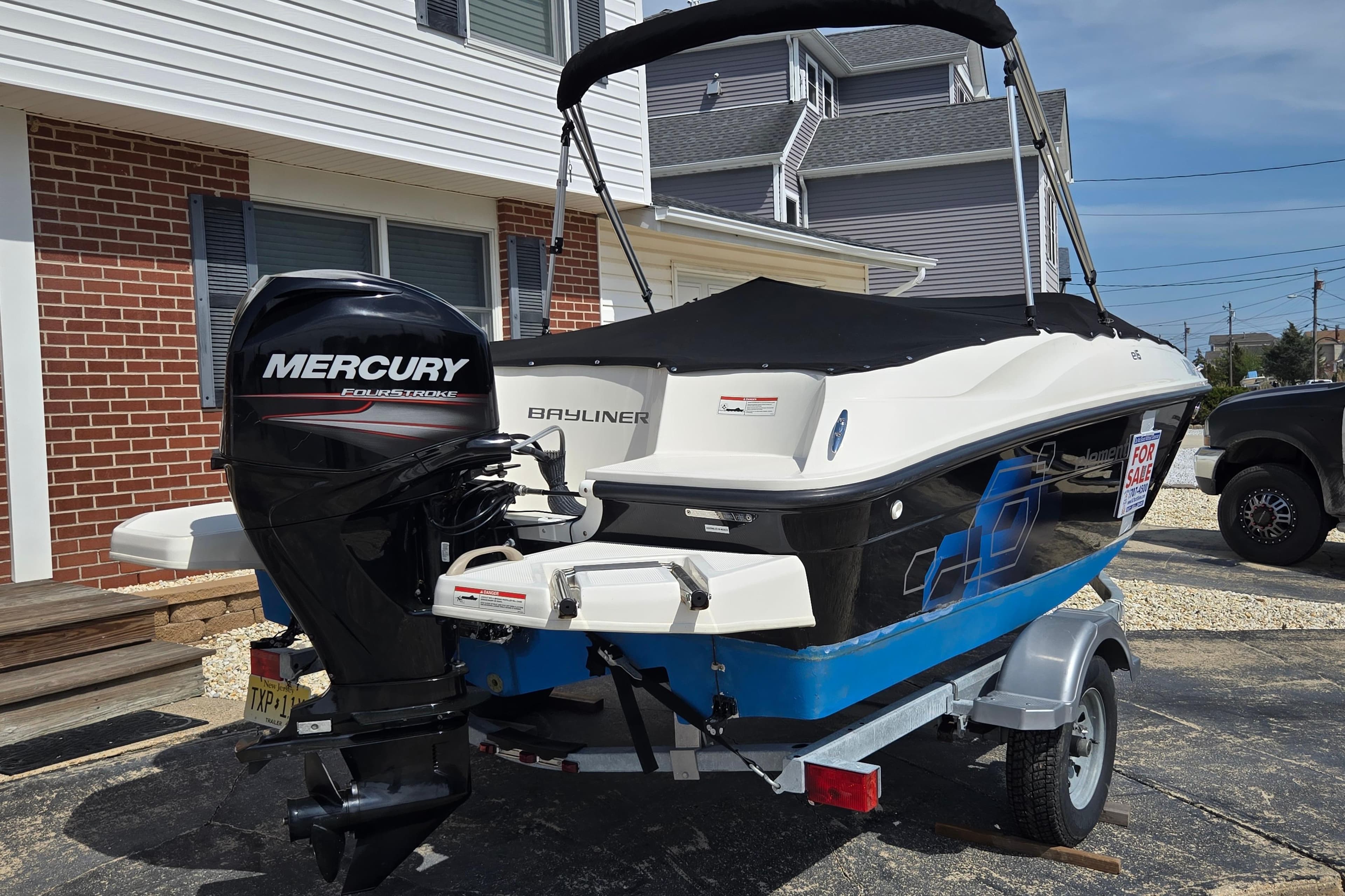2019 Bayliner Element E16 boat with Mercury engine, parked on trailer, for sale.