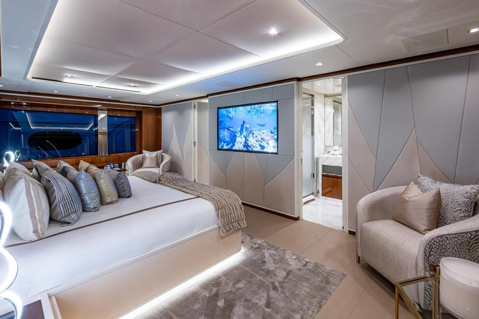 Luxurious interior of 2020 Overmarine Gransport 54 yacht with elegant bedroom and modern decor.