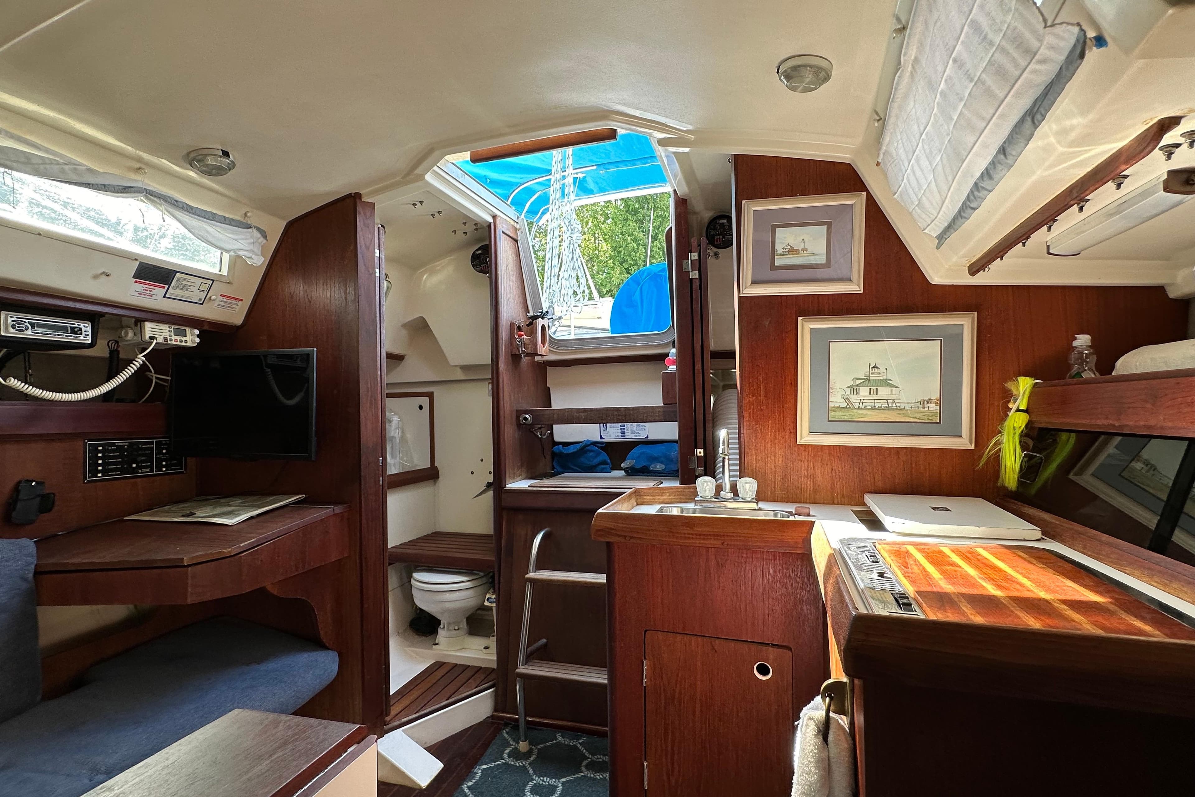 Interior of 1985 Hunter 28.5 sailboat with cozy cabin and nautical decor.