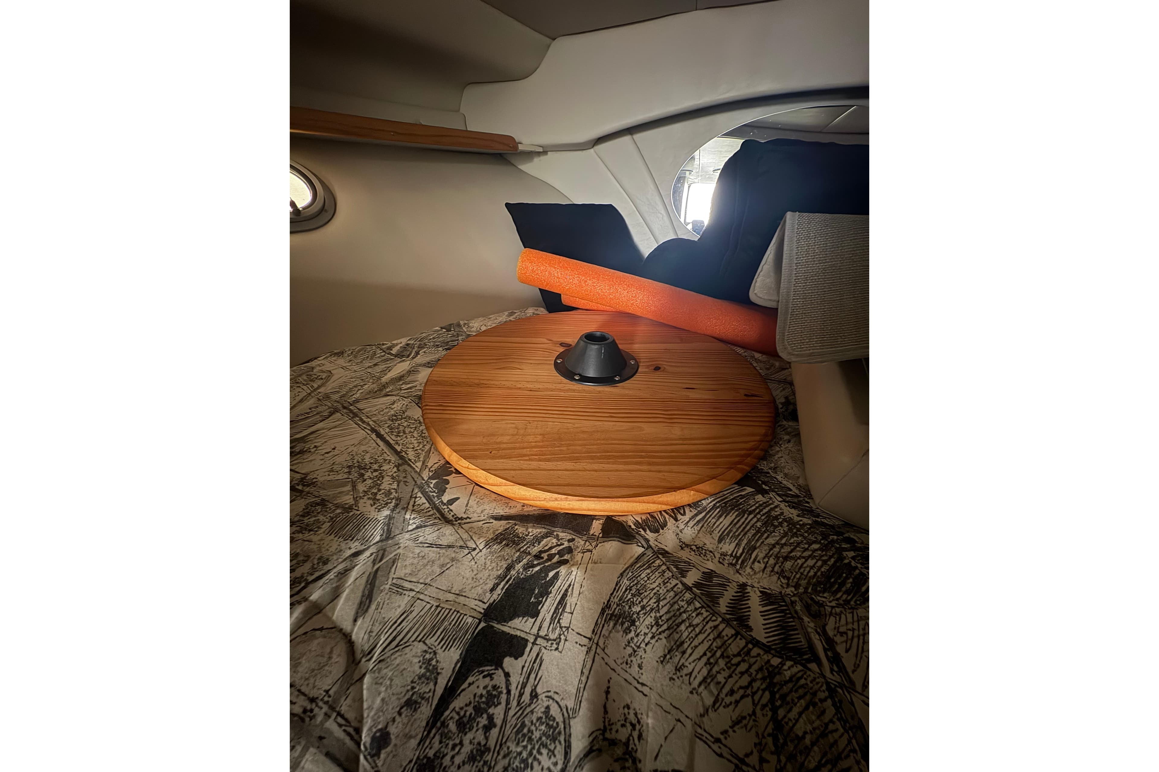 Interior of 1999 Four Winns 328 Vista boat with wooden table and patterned upholstery.
