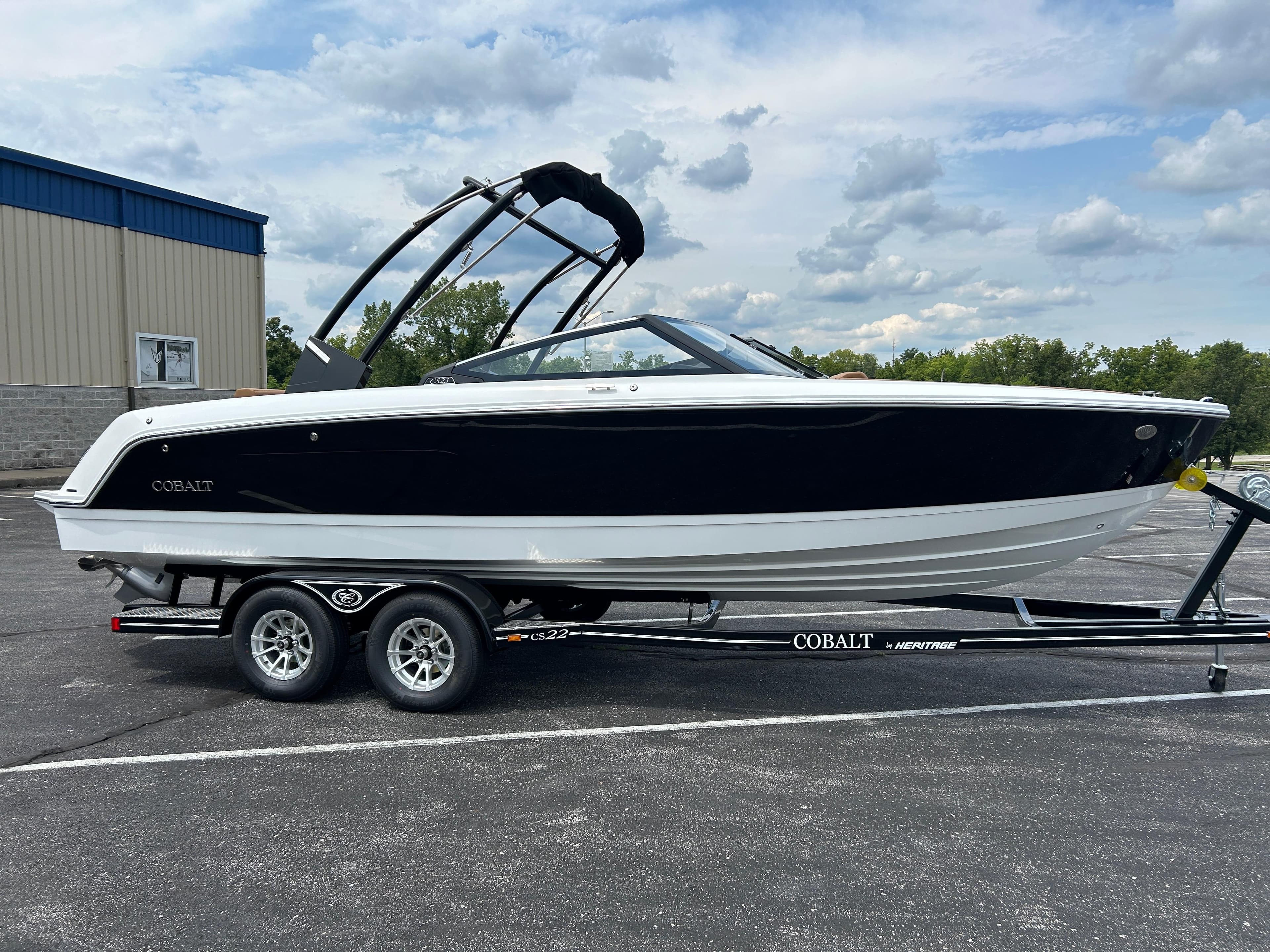 2025 Cobalt CS23 boat on a trailer in a parking lot.