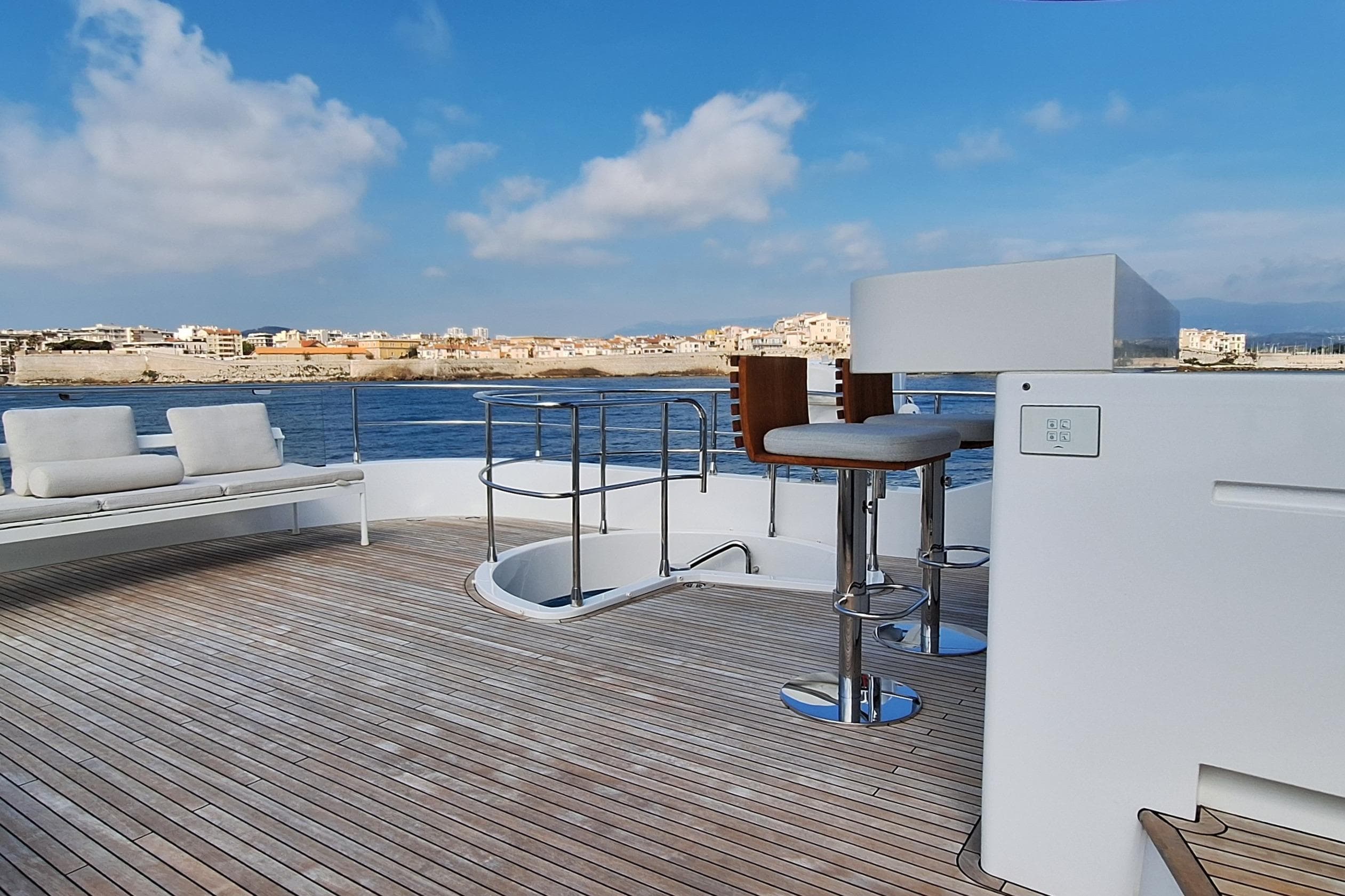 Luxurious deck of 2022 Azimut Magellano 25M yacht with seating and ocean view.