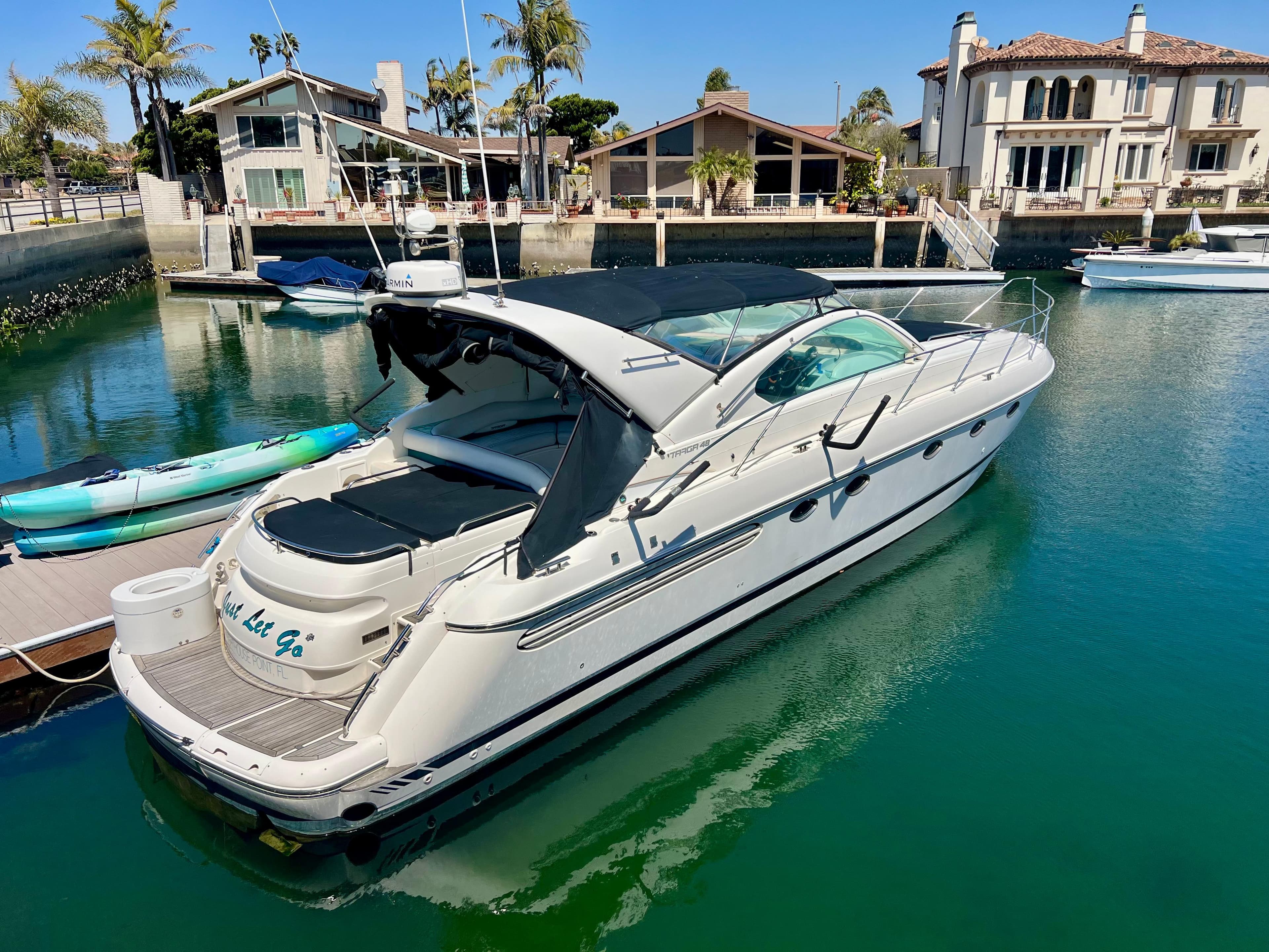 1999 Fairline Targa 48 Open yacht docked in a serene marina setting.