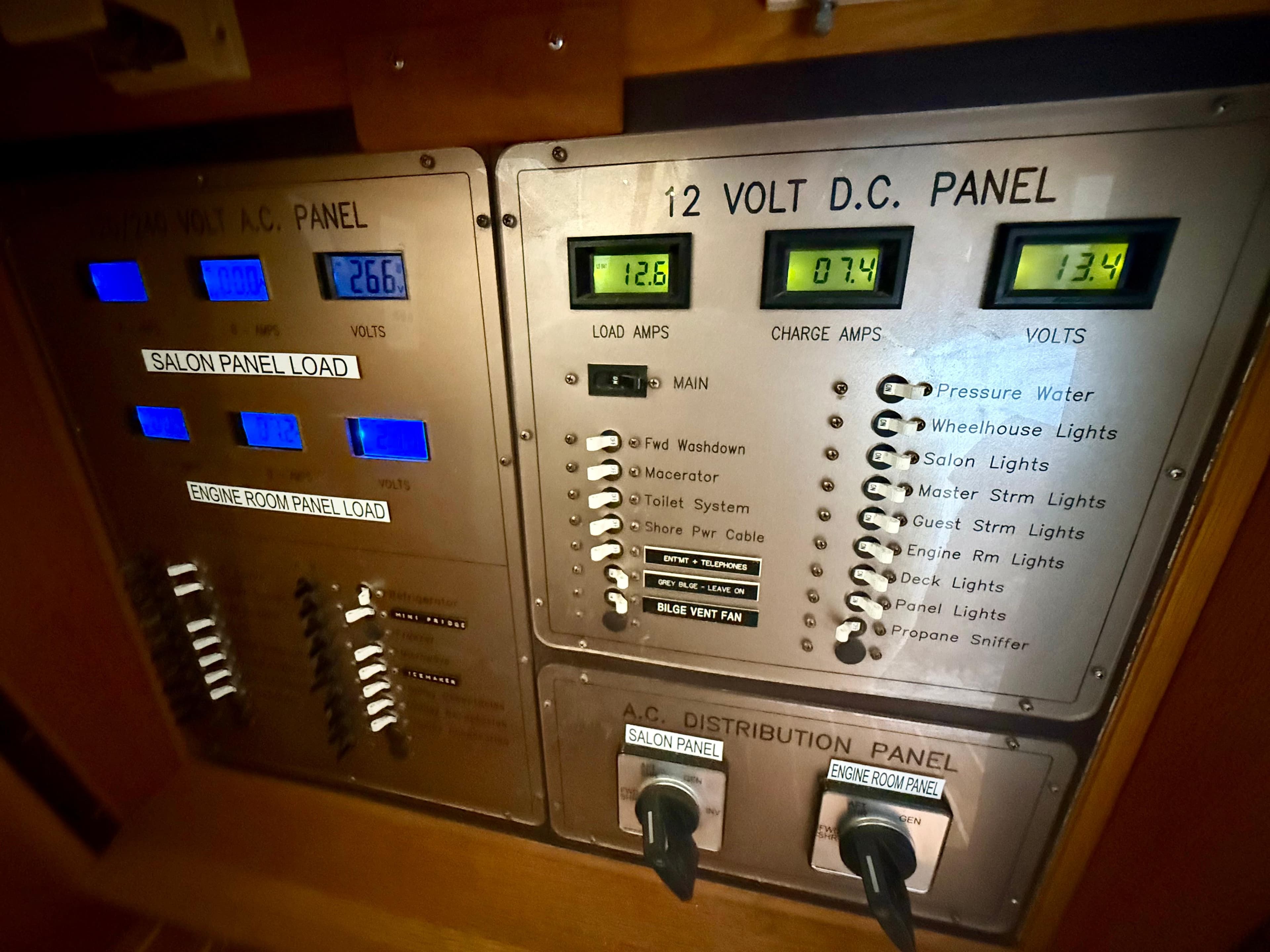 Electrical control panel of 1997 West Bay Sonship 58 Pilothouse yacht, showing voltage and load indicators.