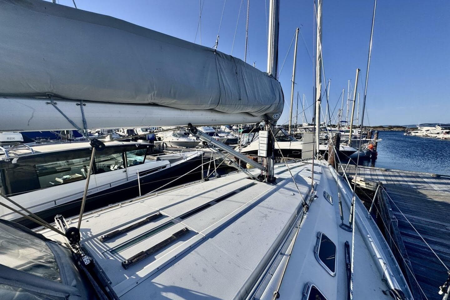 Sailboat Beneteau First 45f5, 1991 model, docked at marina under clear blue sky.