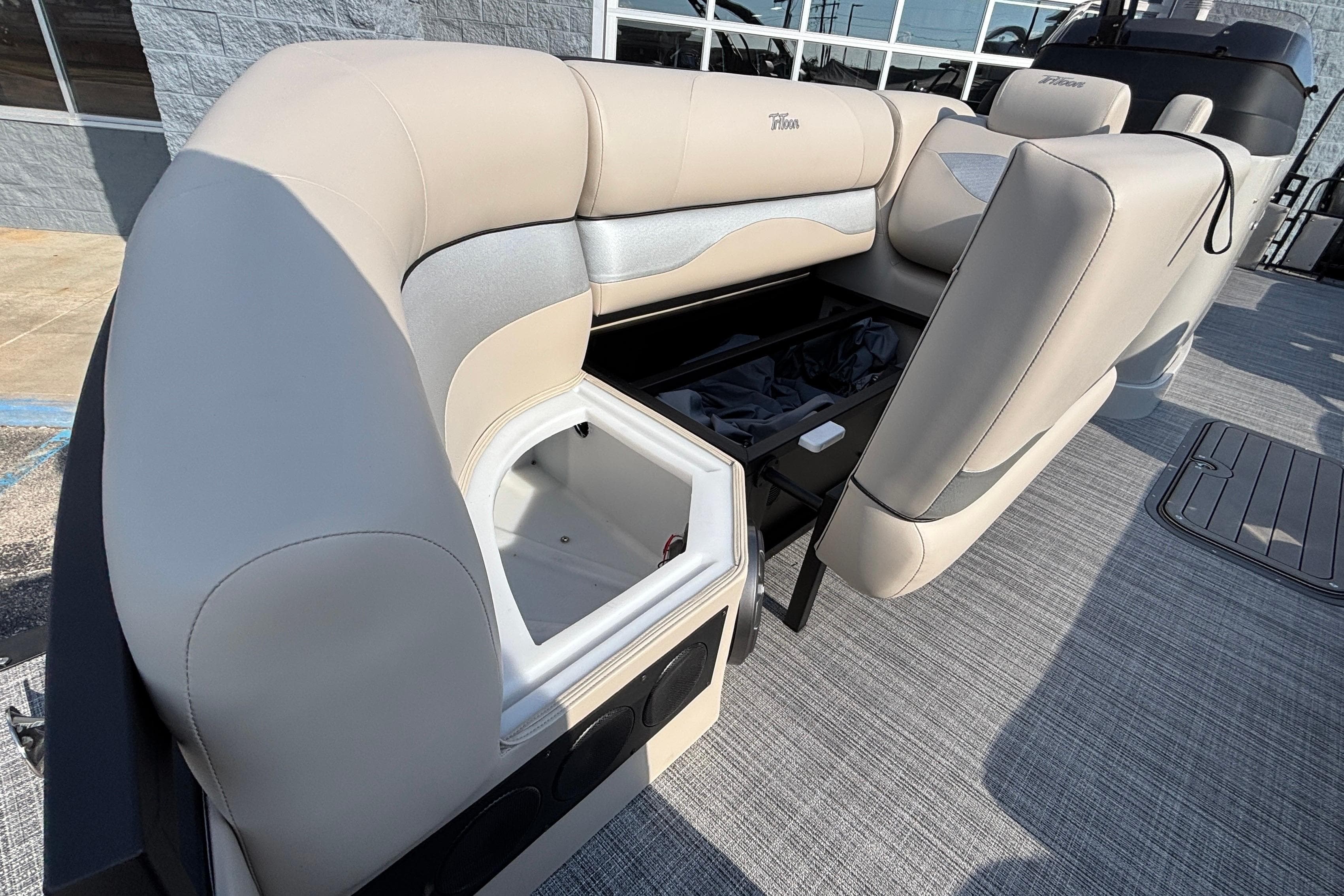 2026 JC Neptoon 25TT Sport boat interior with open storage compartment and seating.