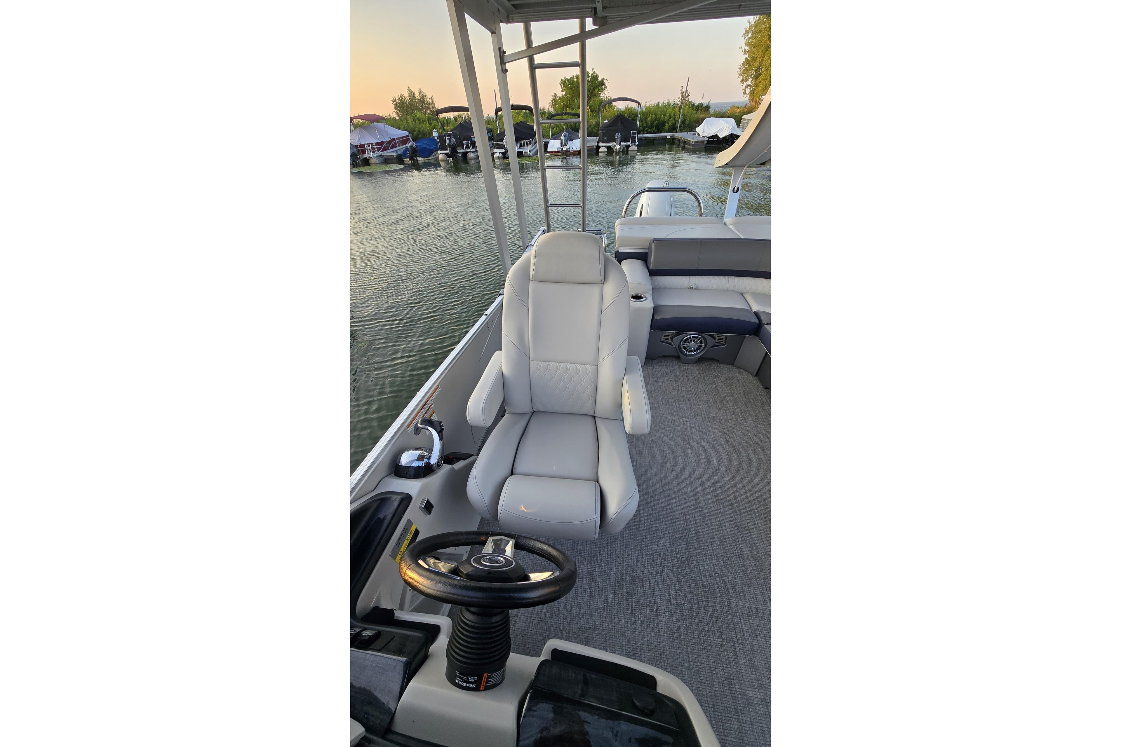 2023 Avalon Catalina 2585 CRFS Funship interior with captain's chair and steering wheel.