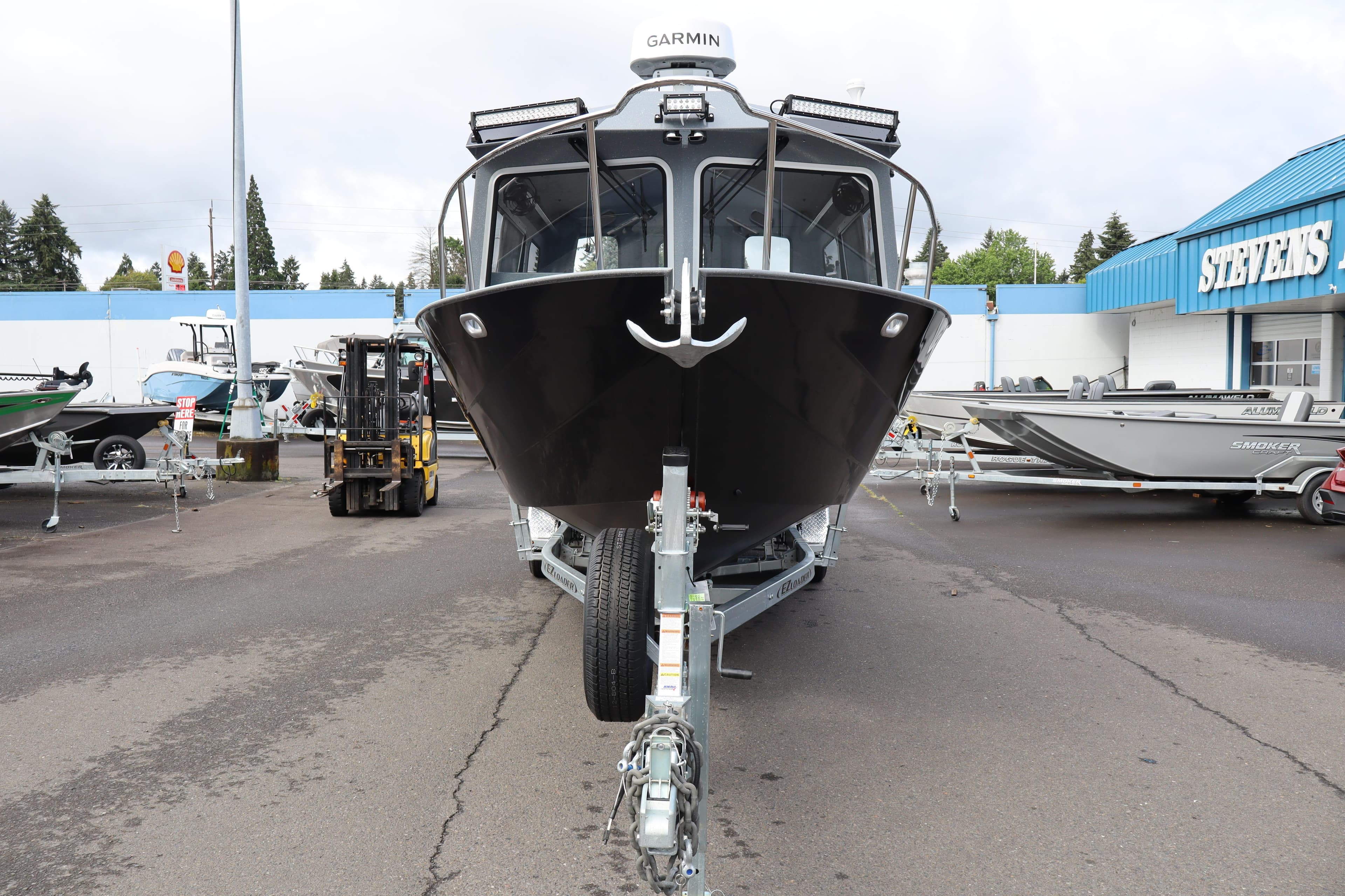 2026 KingFisher 2825 Coastal Express boat on trailer at dealership lot.