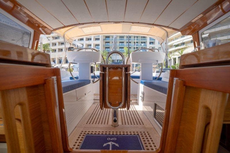2023 Hallberg-Rassy 50 yacht cockpit with elegant wood finish and modern design.