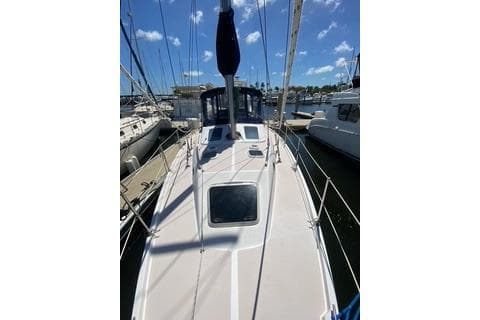 2003 Morgan/Catalina 381 CC sailboat docked at marina under blue sky.