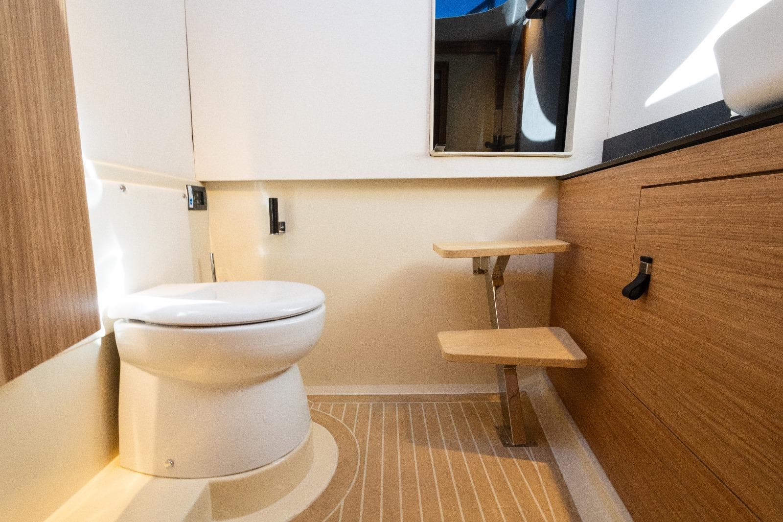 Modern bathroom interior in AlCustom LIPARI 31 yacht, 2025 model, featuring wood accents and sleek design.