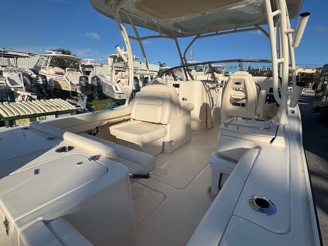 2025 Grady-White Freedom 235 boat interior with seating and helm, displayed outdoors.