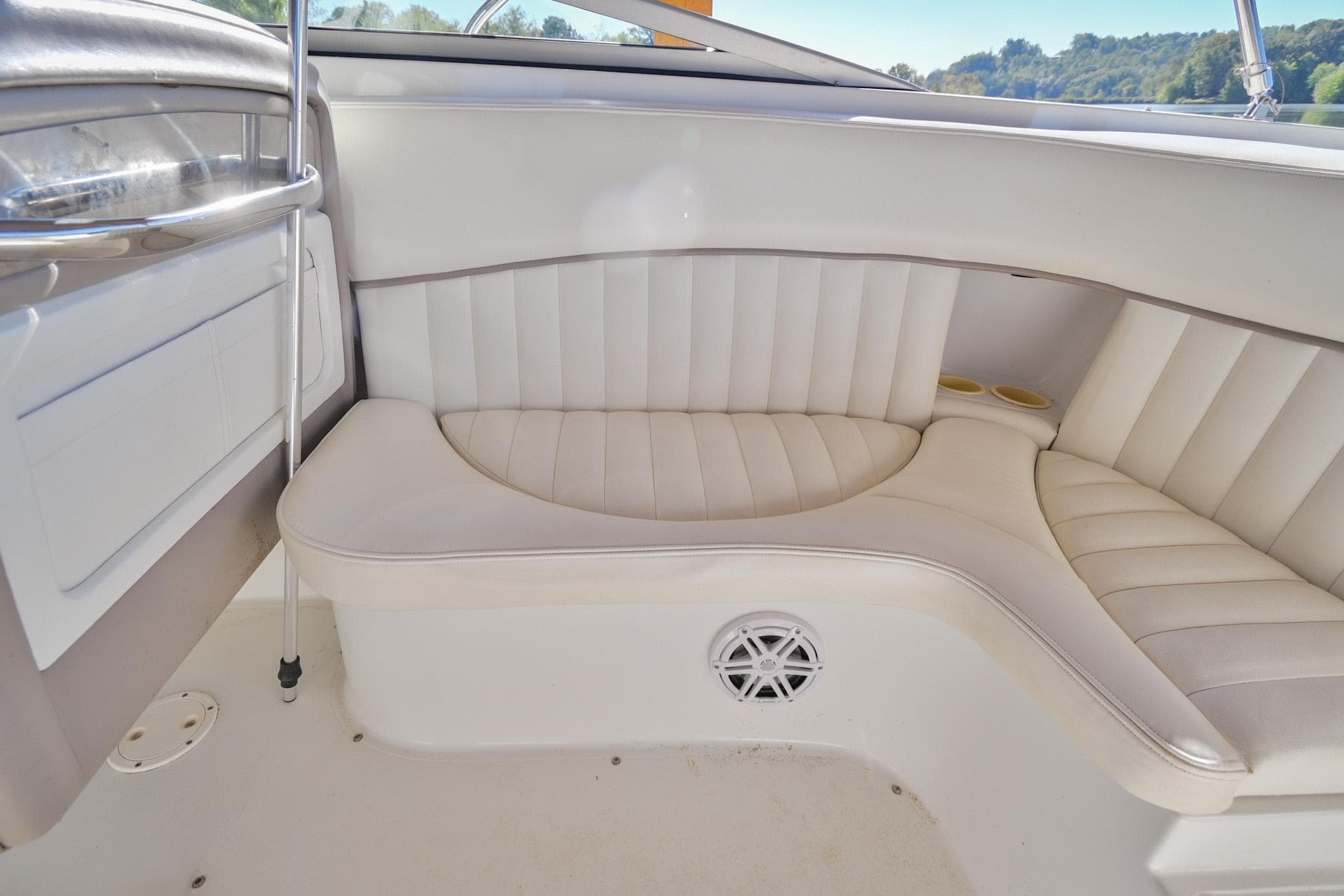 2002 Cobalt 262 boat interior with white cushioned seating and speaker.