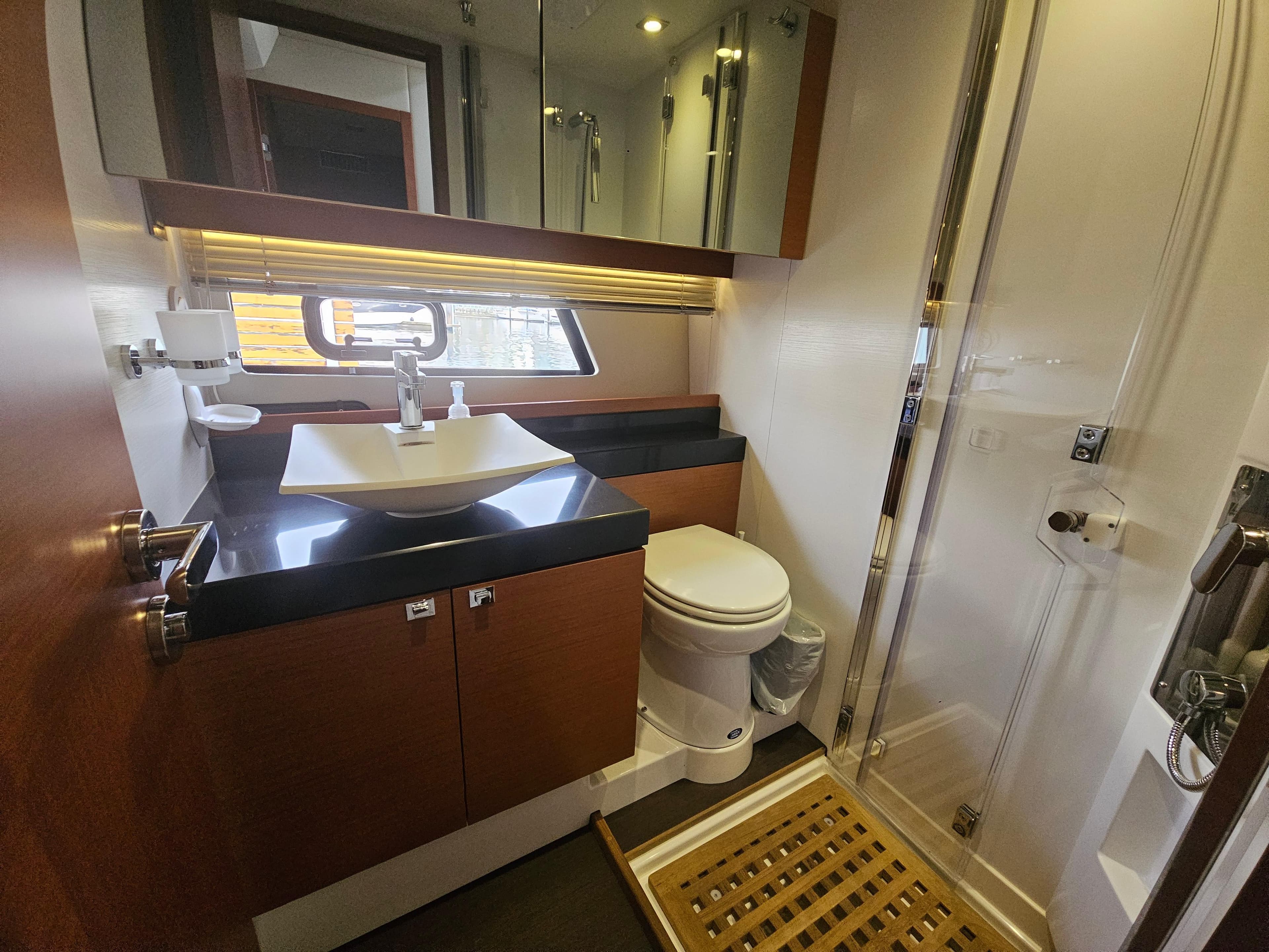 Luxurious bathroom in 2016 Prestige 500 S yacht with modern fixtures and wooden accents.