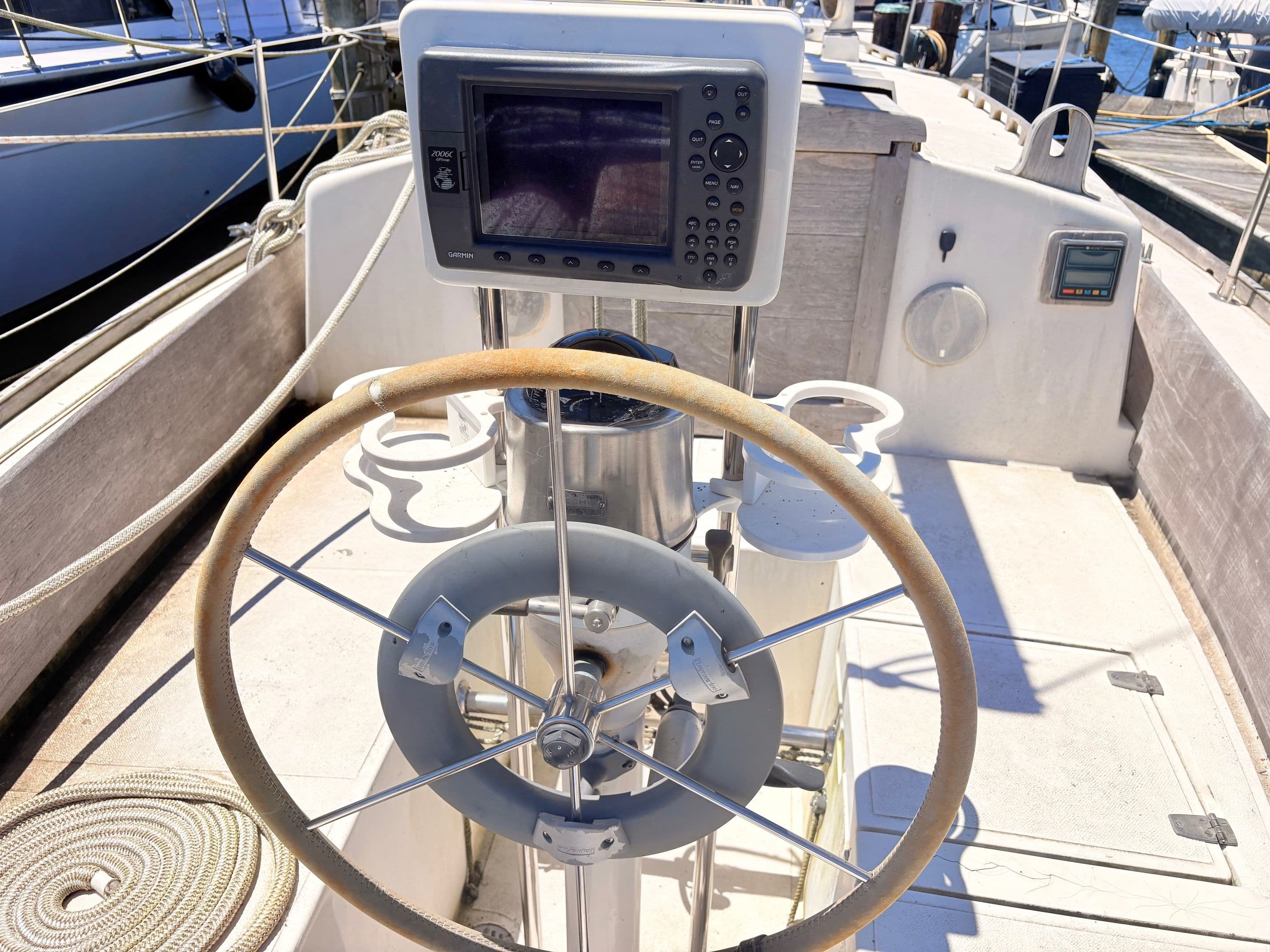 Steering wheel of a 1972 Tartan 34 Classic yacht in harbor.
