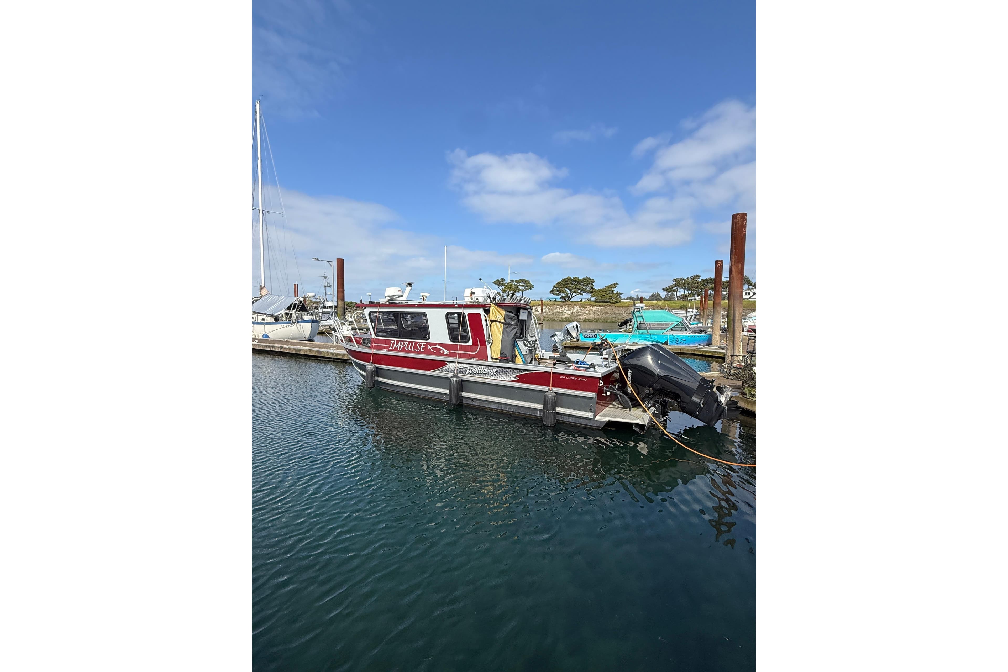 2017 Weldcraft 260 Cuddy King boat docked in a marina under a clear blue sky.