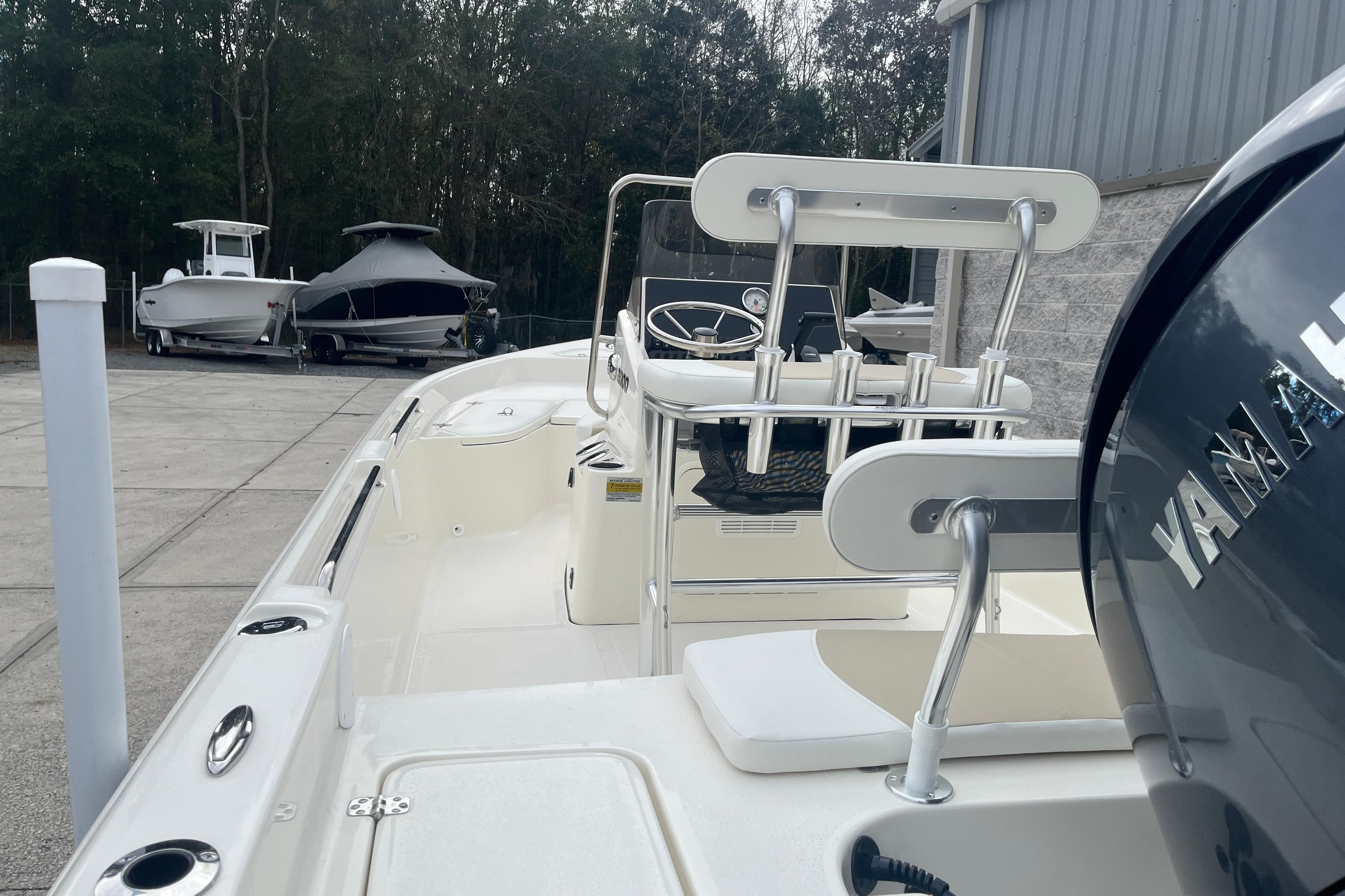 2026 Bulls Bay 2000 boat with Yamaha engine, docked outdoors near other boats.