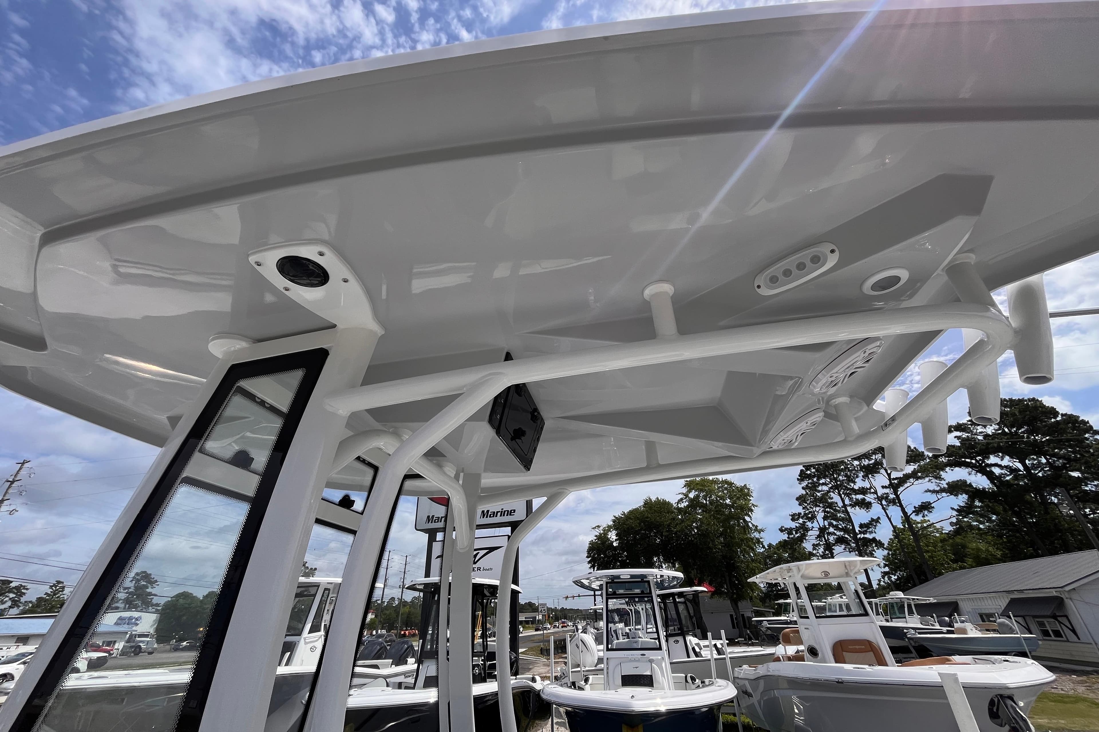 2026 Tidewater 210 LXF boat with sleek design and modern features under a clear sky.