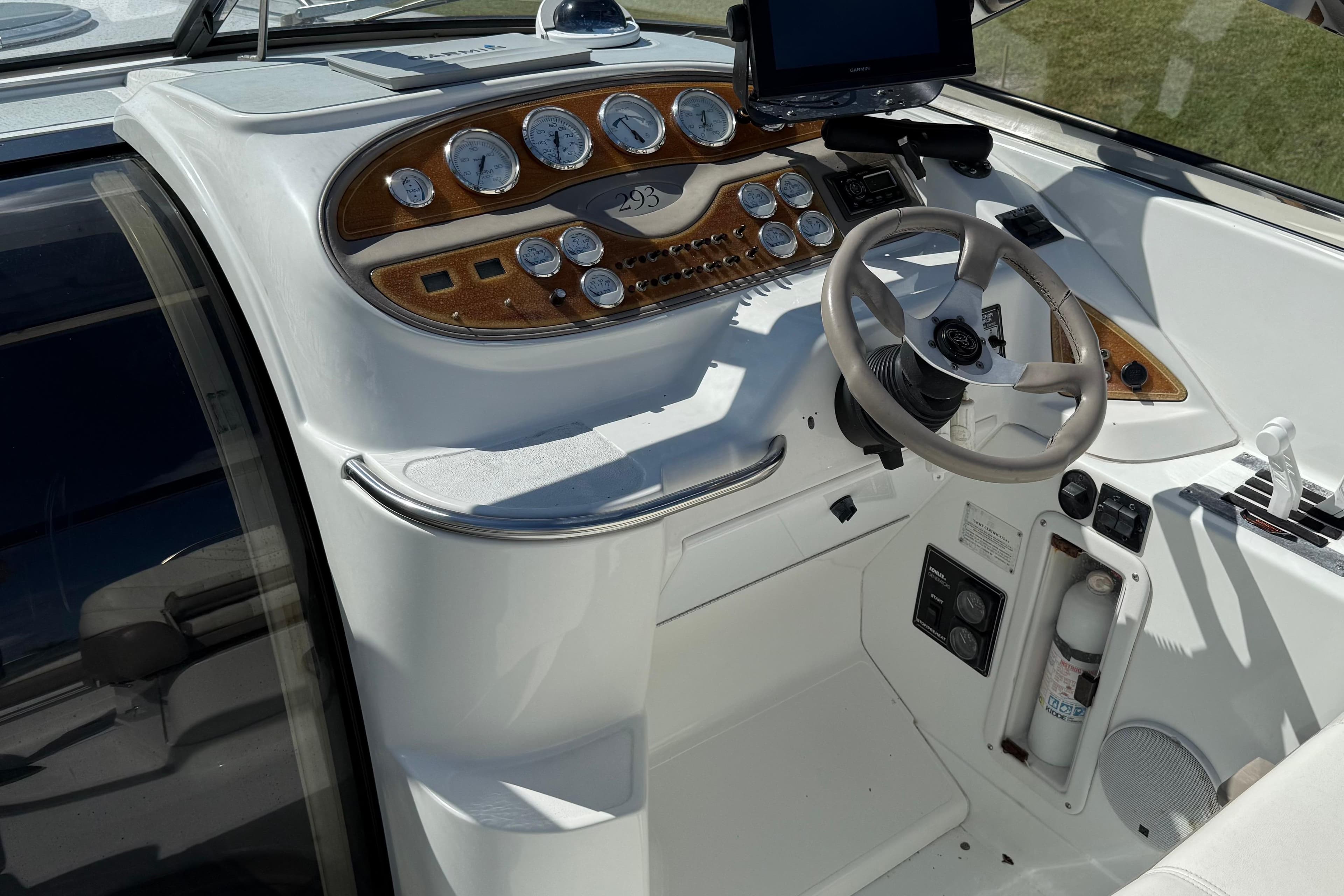 Cockpit of a 1999 Cobalt 293 boat with steering wheel and control panel.