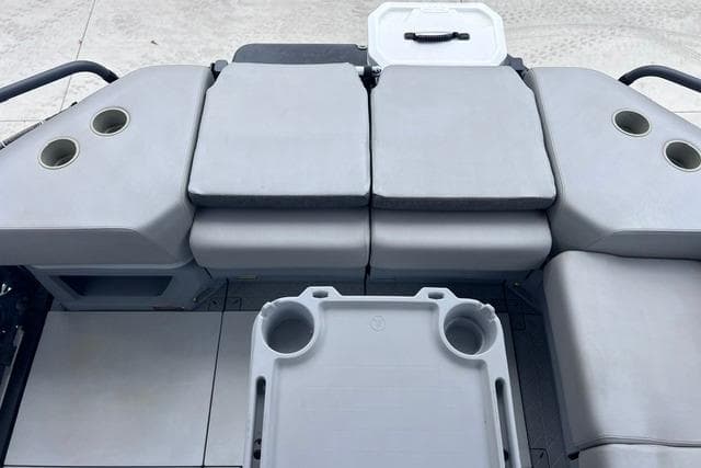 2022 Seadoo Switch boat interior with cushioned seating and cup holders.