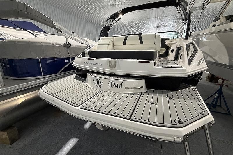 2016 Regal 24 FasDeck RX boat with "Lily Pad" name, docked indoors.