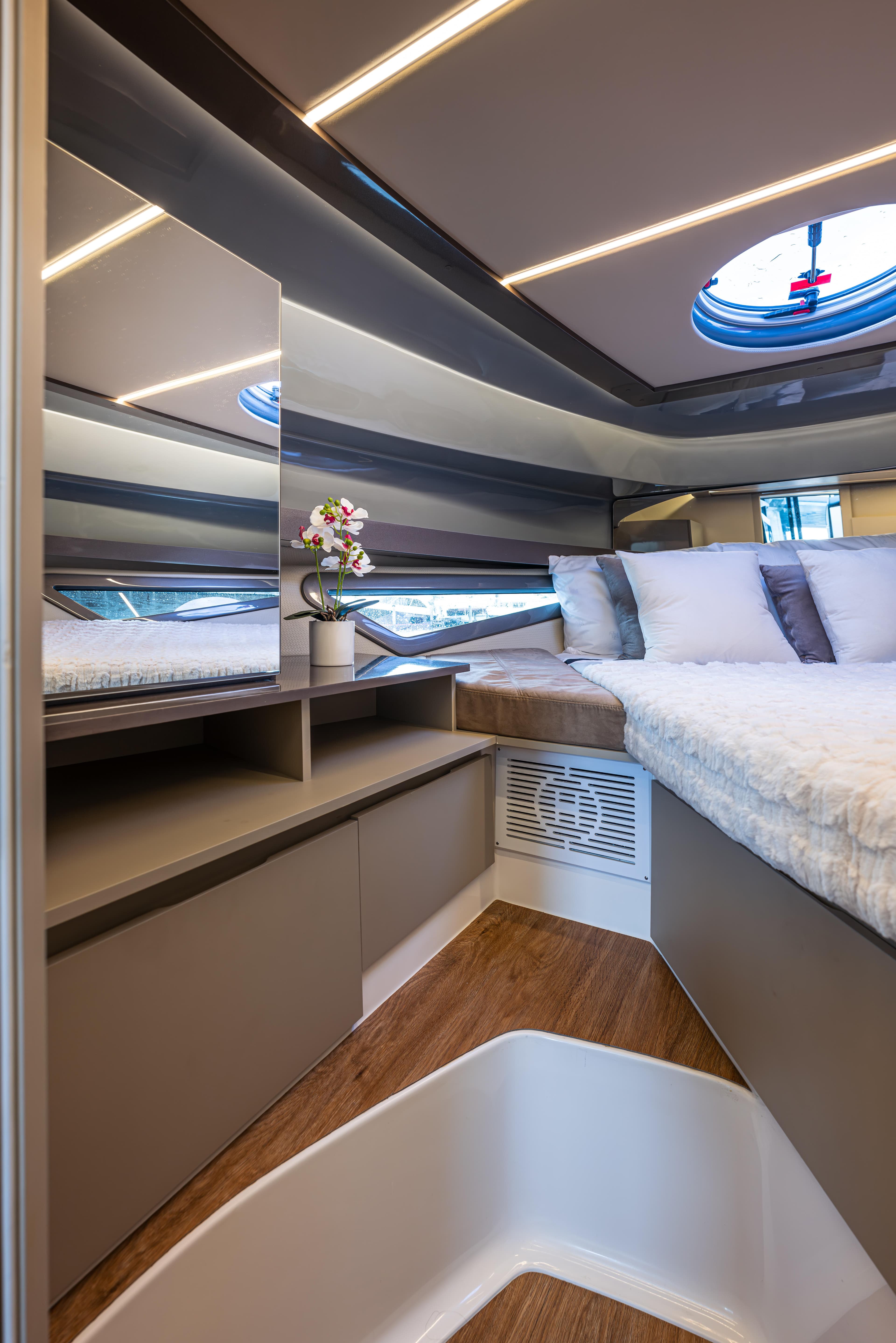 Luxurious interior of 2025 Hanover 415 yacht with modern design and cozy bedding.